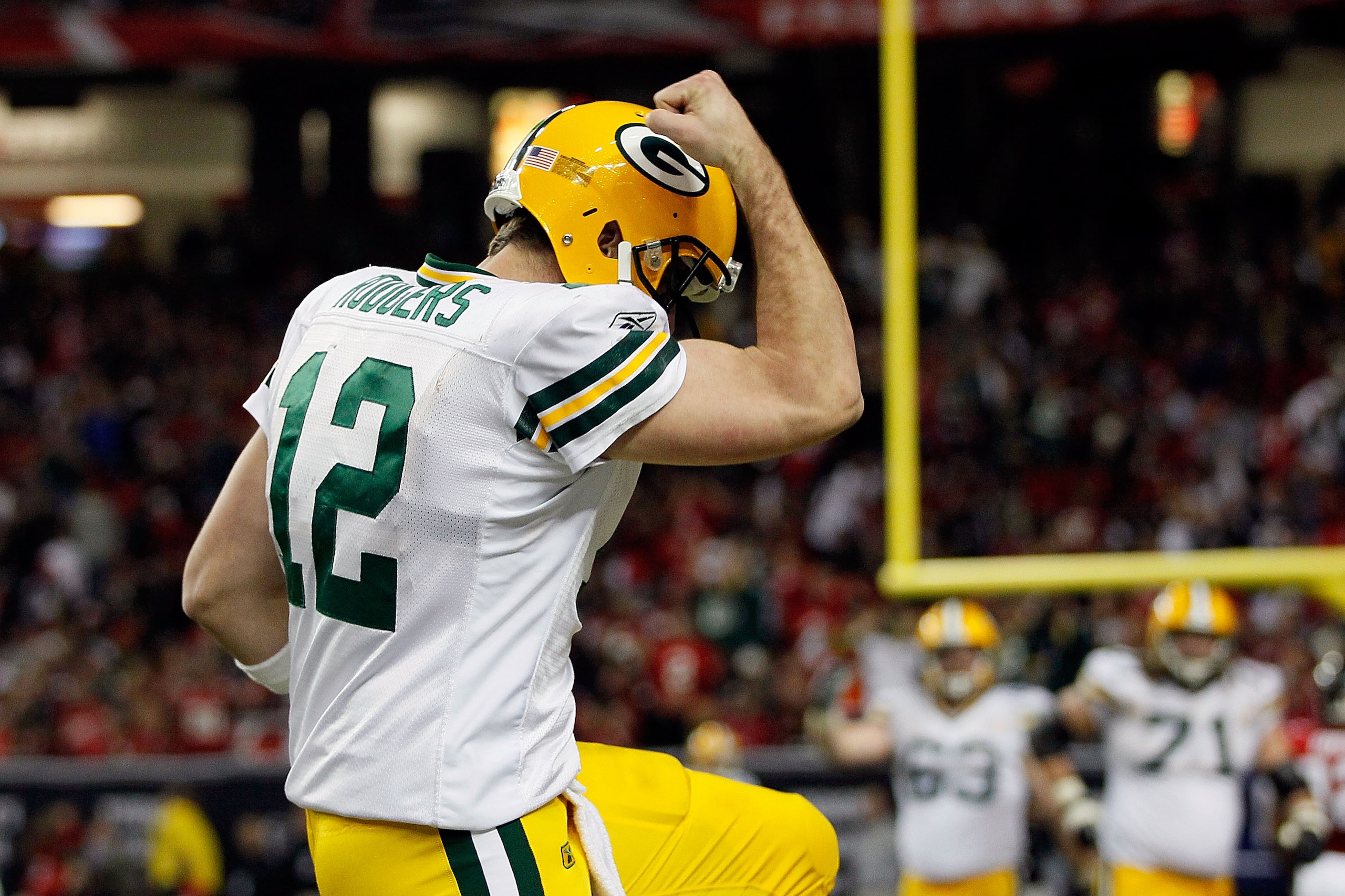 ATLANTA, GA - JANUARY 15:  Aaron Rodgers #12 of the Green Bay Packers reacts after he threw a 7-yard touchdown to John Kuhn #30 in the third quarter against the Atlanta Falcons during their 2011 NFC divisional playoff game at Georgia Dome on January 15, 2