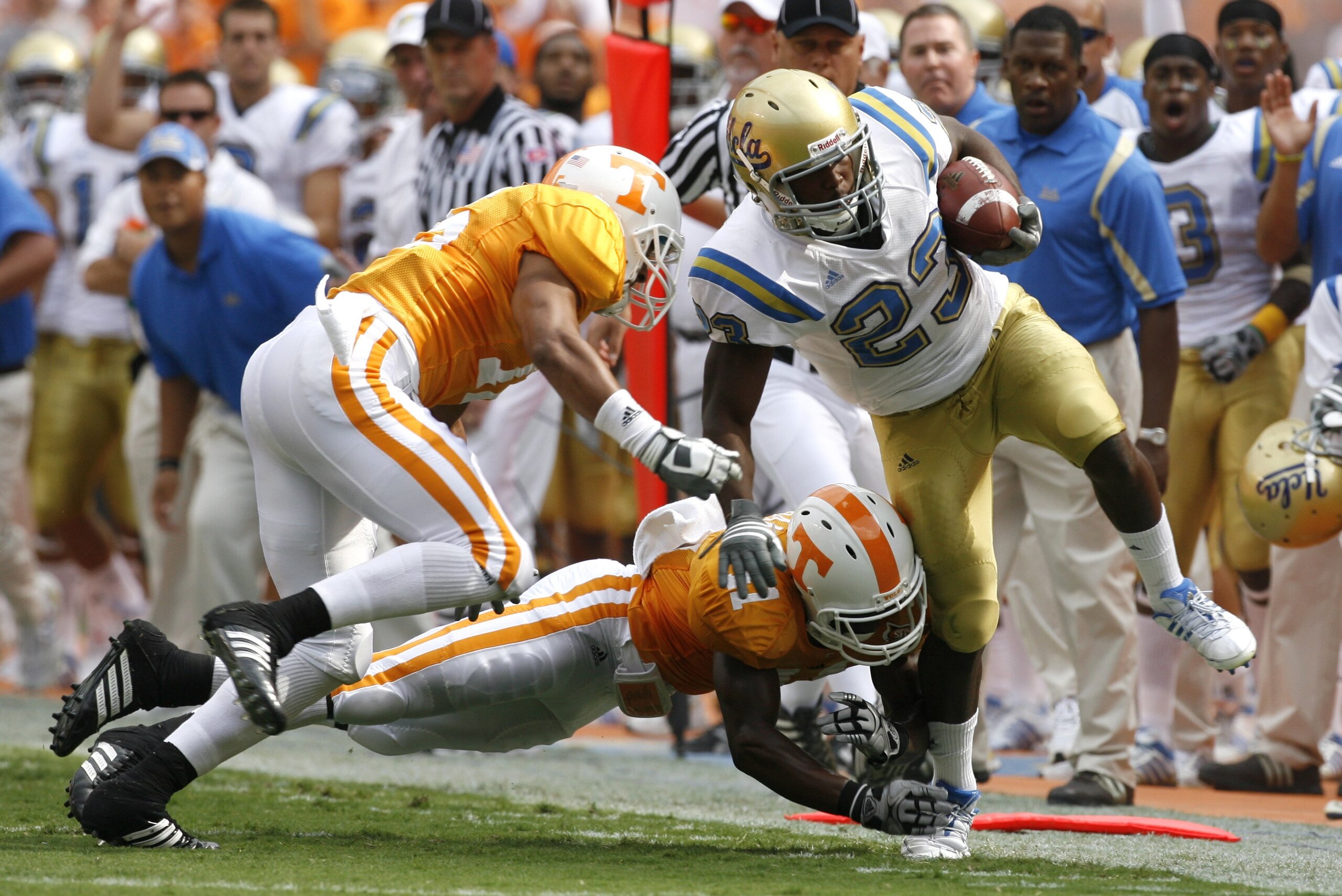 KNOXVILLE, TN - SEPTEMBER 12: Jonathan Franklin #23 of the UCLA Bruins is knocked out of bounds by Janzen Jackson #15 and Dennis Rogan #41 of the Tennessee Volunteers on September 12, 2009 at Neyland Stadium in Knoxville, Tennessee. UCLA beat Tennessee 19 KNOXVILLE, TN - SEPTEMBER 12: Jonathan Franklin #23 of the UCLA Bruins is knocked out of bounds by Janzen Jackson #15 and Dennis Rogan #41 of the Tennessee Volunteers on September 12, 2009 at Neyland Stadium in Knoxville, Tennessee. UCLA beat Tennessee 19