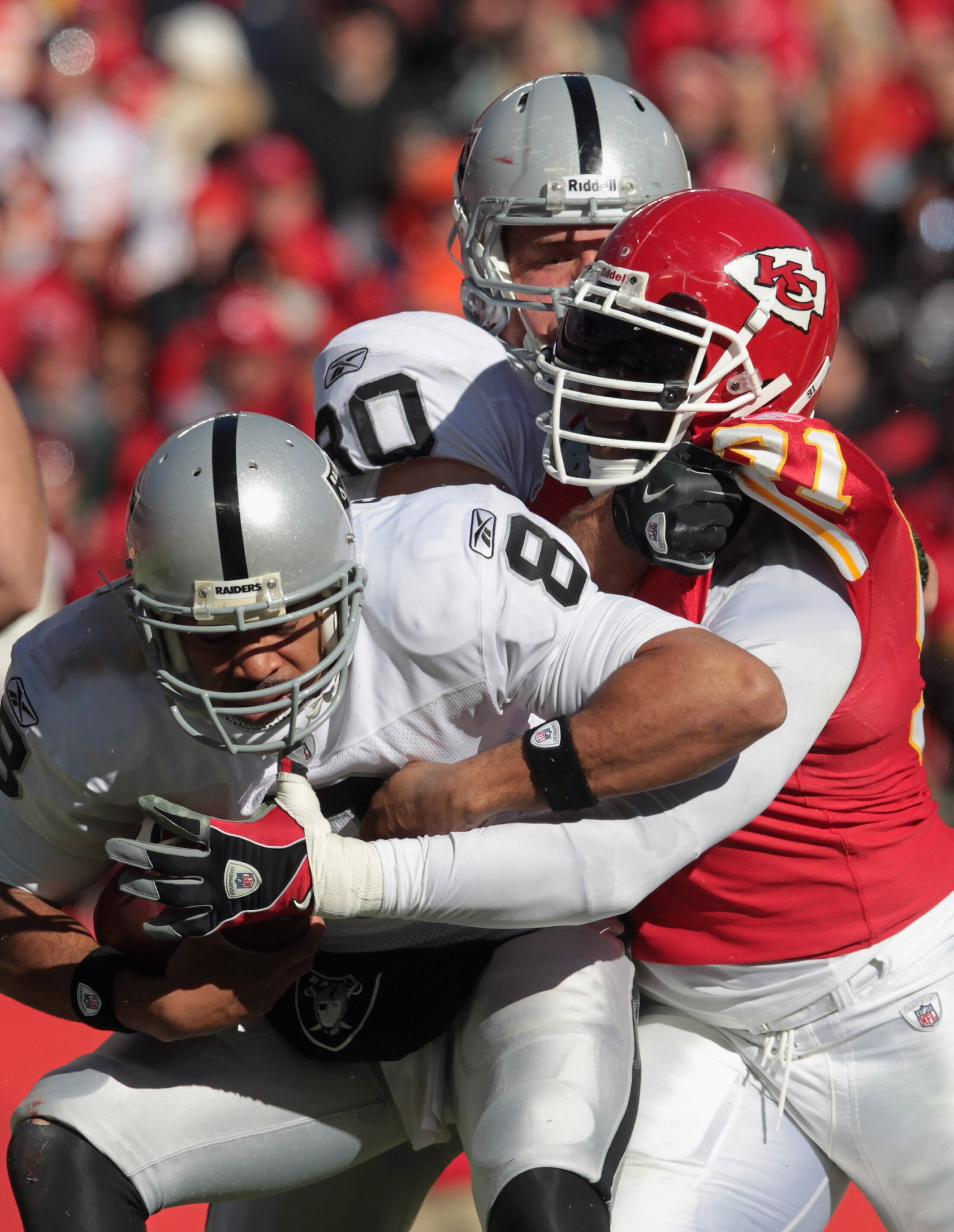 KANSAS CITY, MO - JANUARY 02:  Quarterback Jason Campbell #8 of the Oakland Raiders is sacked by Tamba Hali #91 of the Kansas City Chiefs during the game on January 2, 2011 at Arrowhead Stadium in Kansas City, Missouri.  (Photo by Jamie Squire/Getty Image