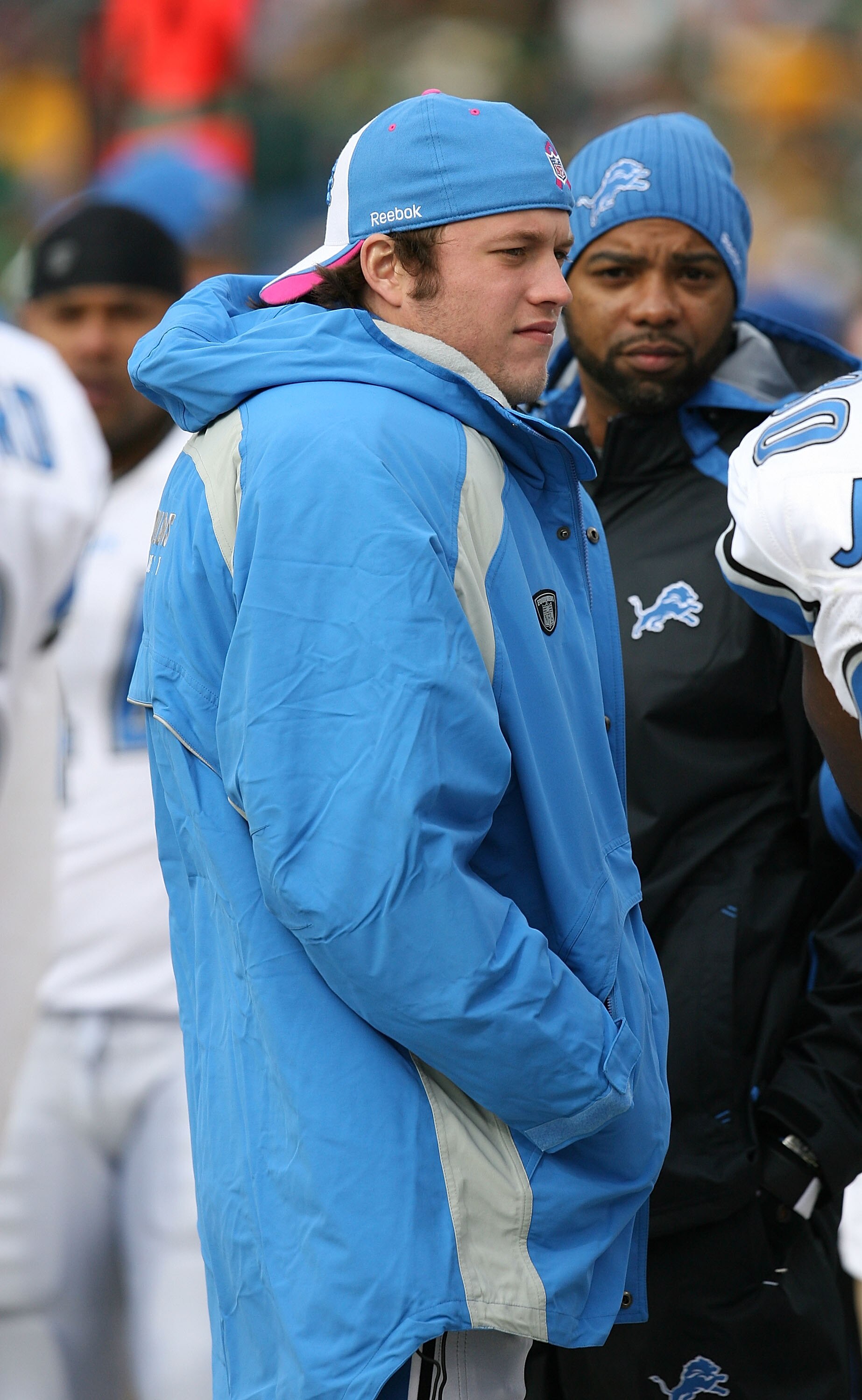 GREEN BAY, WI - OCTOBER 18:  Injured quarterback Matthew Stafford #9 of the Detroit Lions talks with teammates on the sidelines during a game against the Green Bay Packers at Lambeau Field on October 18, 2009 in Green Bay, Wisconsin. The Packers defeated