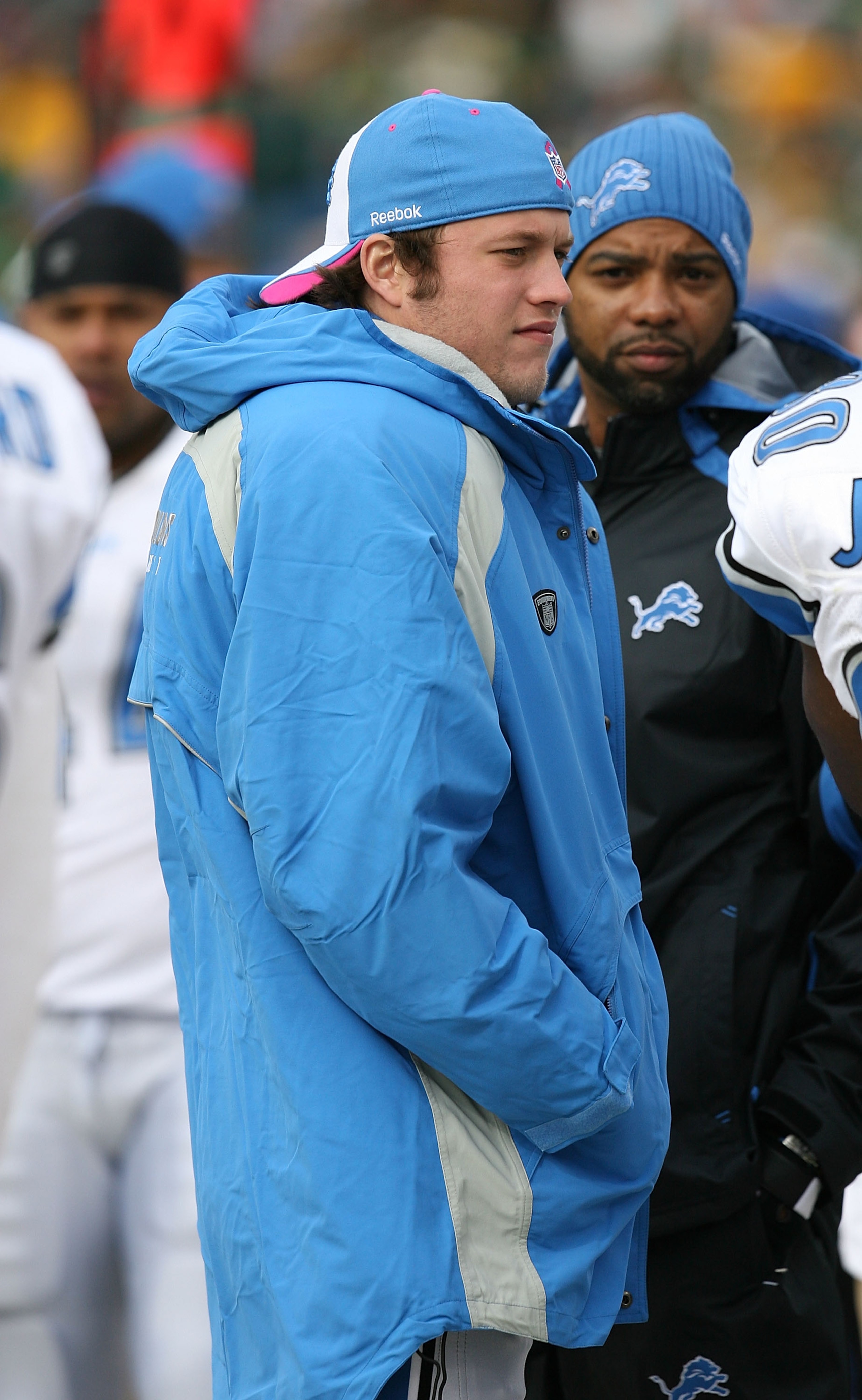 GREEN BAY, WI - OCTOBER 18:  Injured quarterback Matthew Stafford #9 of the Detroit Lions talks with teammates on the sidelines during a game against the Green Bay Packers at Lambeau Field on October 18, 2009 in Green Bay, Wisconsin. The Packers defeated