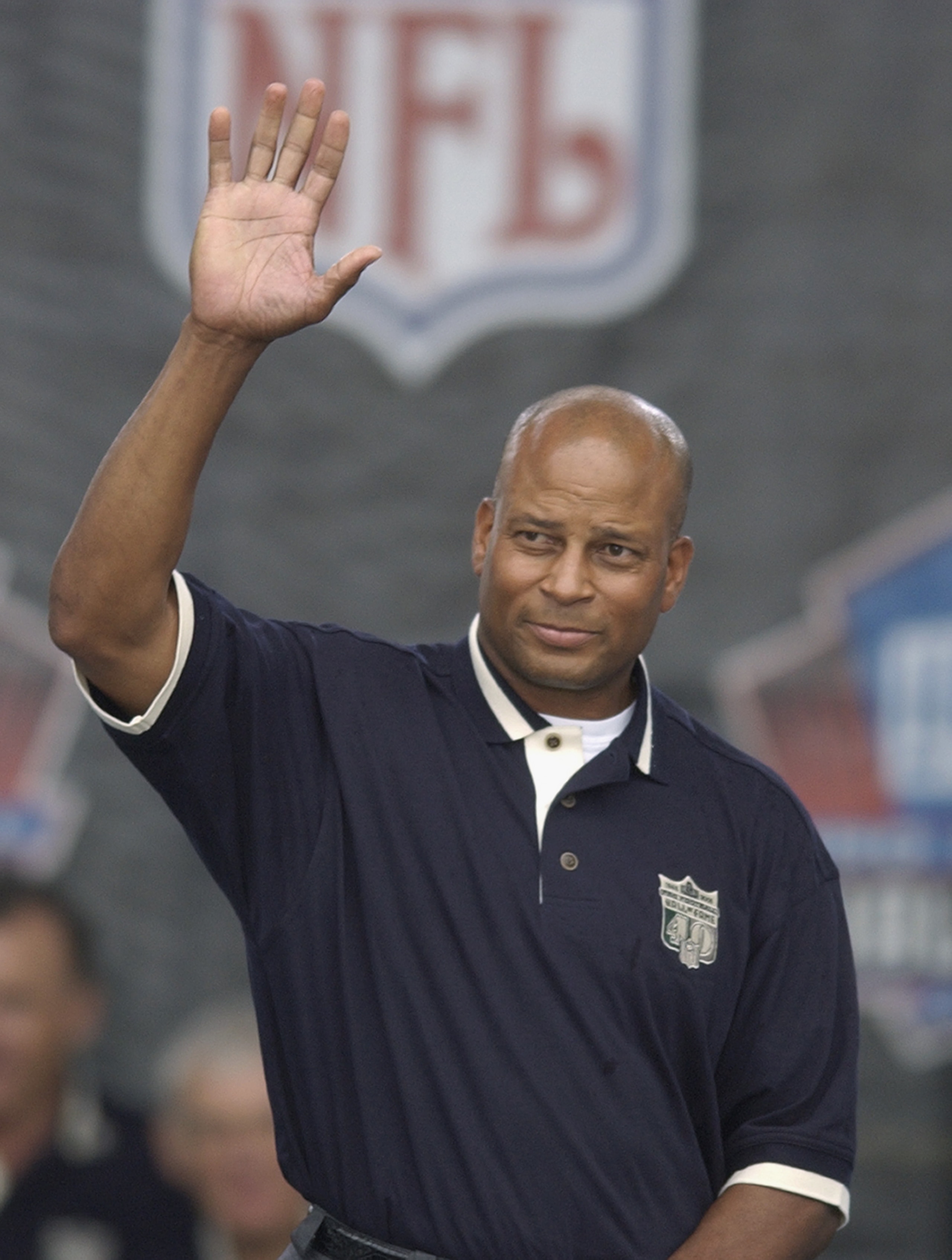 CANTON, OH - AUGUST 3:  Pro Football Hall of Famer (Class of 2000) Ronnie Lott waves as he is introduced during the 2003 NFL Hall of Fame Induction ceremony on August 3, 2003 in Canton, Ohio.  (Photo by David Maxwell/Getty Images)