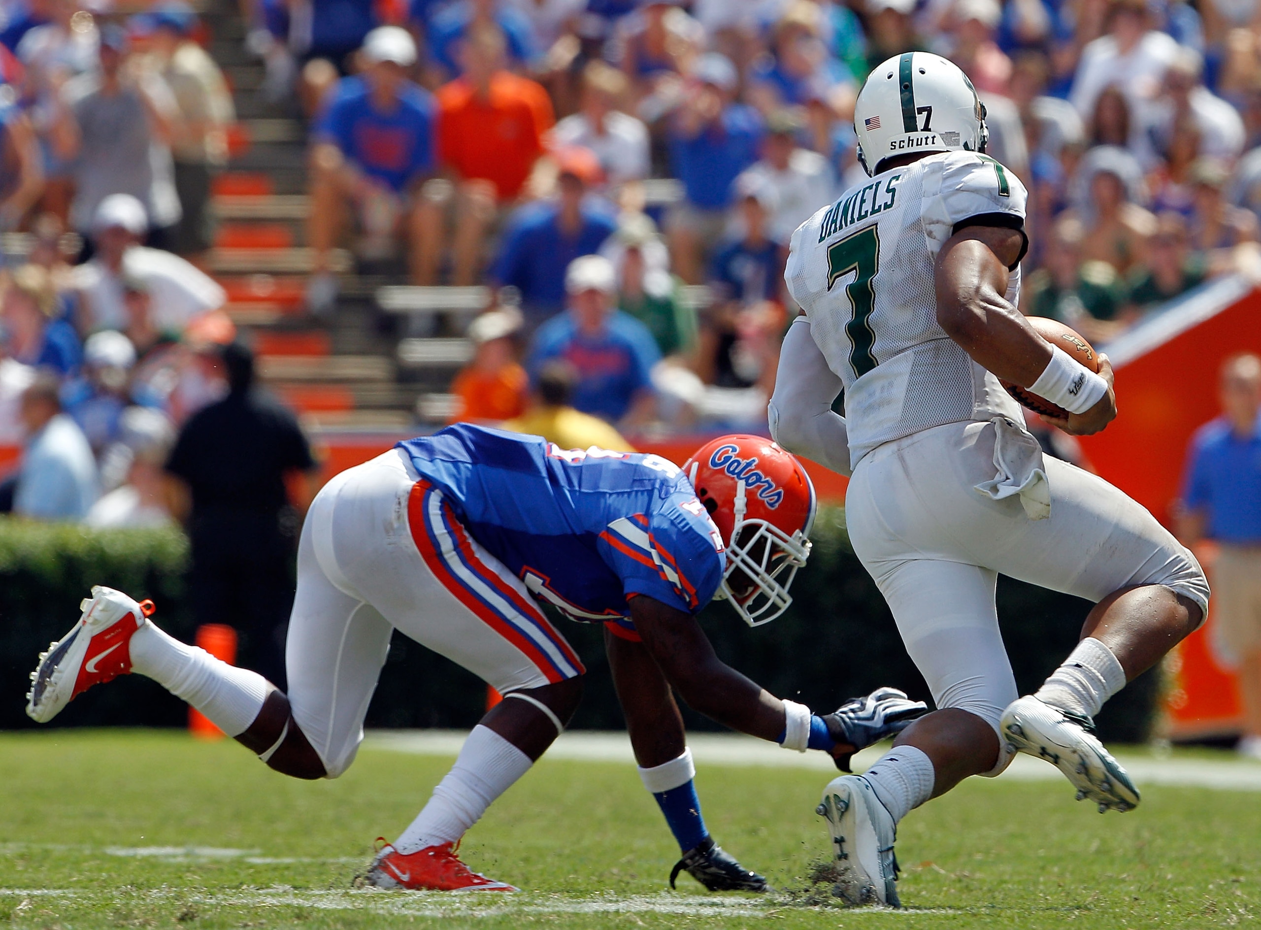 GAINESVILLE, FL - SEPTEMBER 11: Brandon Hicks #40 of the Florida Gators attempts to tackle B.J. Daniels #7 of the South Florida Bulls during a game at Ben Hill Griffin Stadium on September 11, 2010 in Gainesville, Florida. (Photo by Sam Greenwood/Getty GAINESVILLE, FL - SEPTEMBER 11: Brandon Hicks #40 of the Florida Gators attempts to tackle B.J. Daniels #7 of the South Florida Bulls during a game at Ben Hill Griffin Stadium on September 11, 2010 in Gainesville, Florida. (Photo by Sam Greenwood/Getty