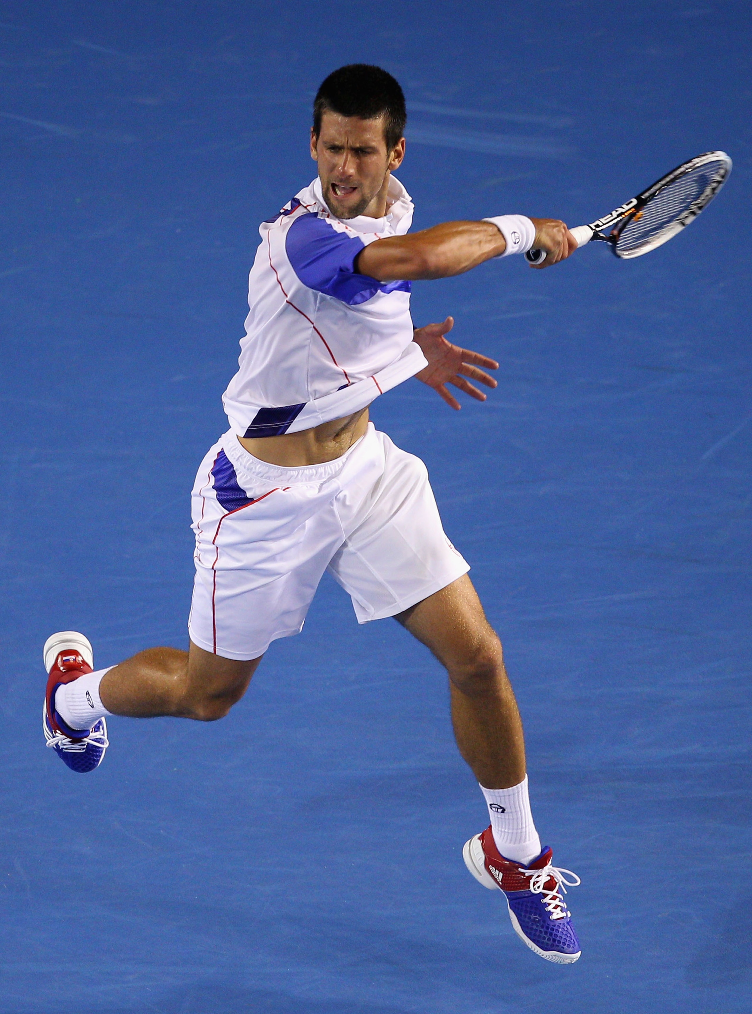 MELBOURNE, AUSTRALIA - JANUARY 25:  Novak Djokovic of Serbia plays a forehand in his quarterfinal match against Tomas Berdych of the Czech Republic  during day nine of the 2011 Australian Open at Melbourne Park on January 25, 2011 in Melbourne, Australia.