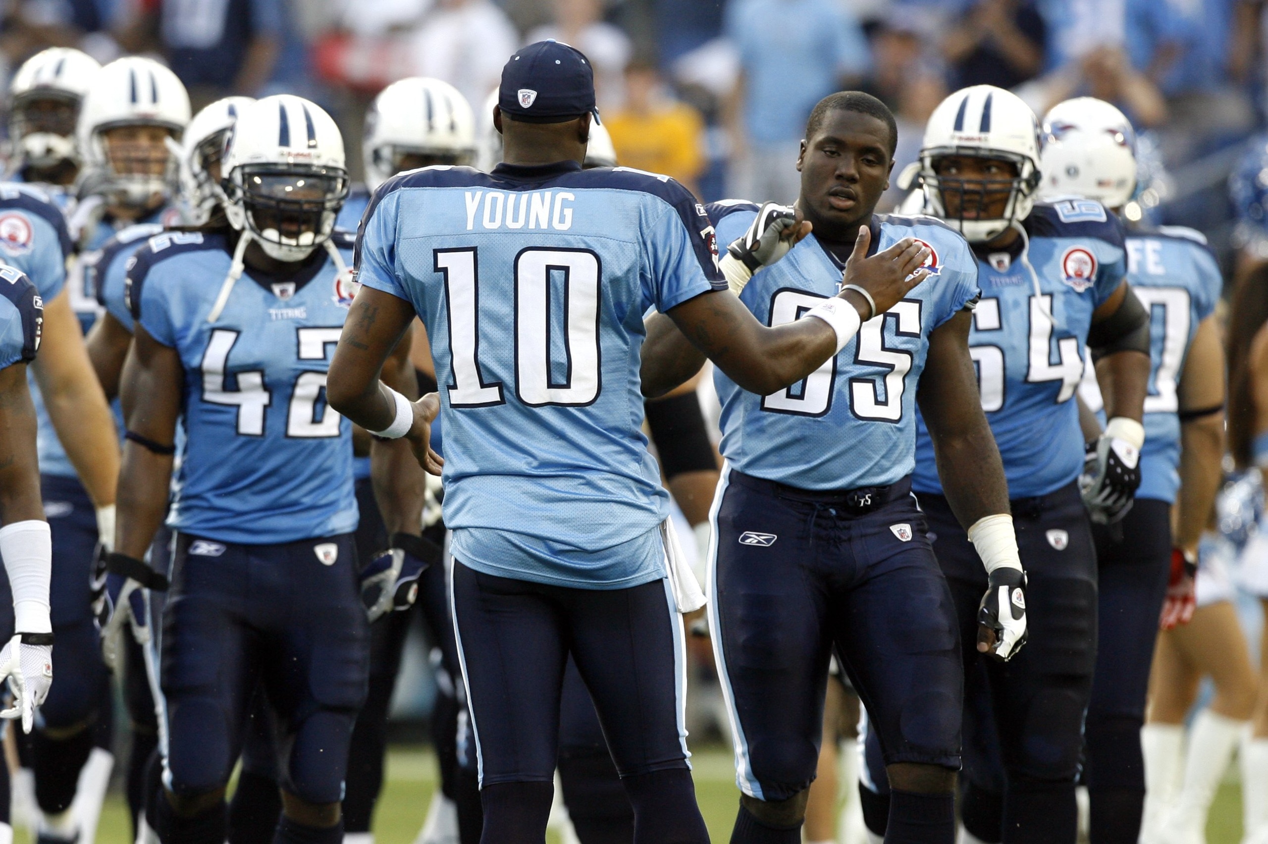 NASHVILLE, TN - AUGUST 15: Vince Young #10 of the Tennessee Titans shakes hands with William Hayes #95 before a game against the Tampa Bay Buccaneers during a preseason NFL game at LP Field on August 15, 2009 in Nashville, Tennessee. The Titans beat the B