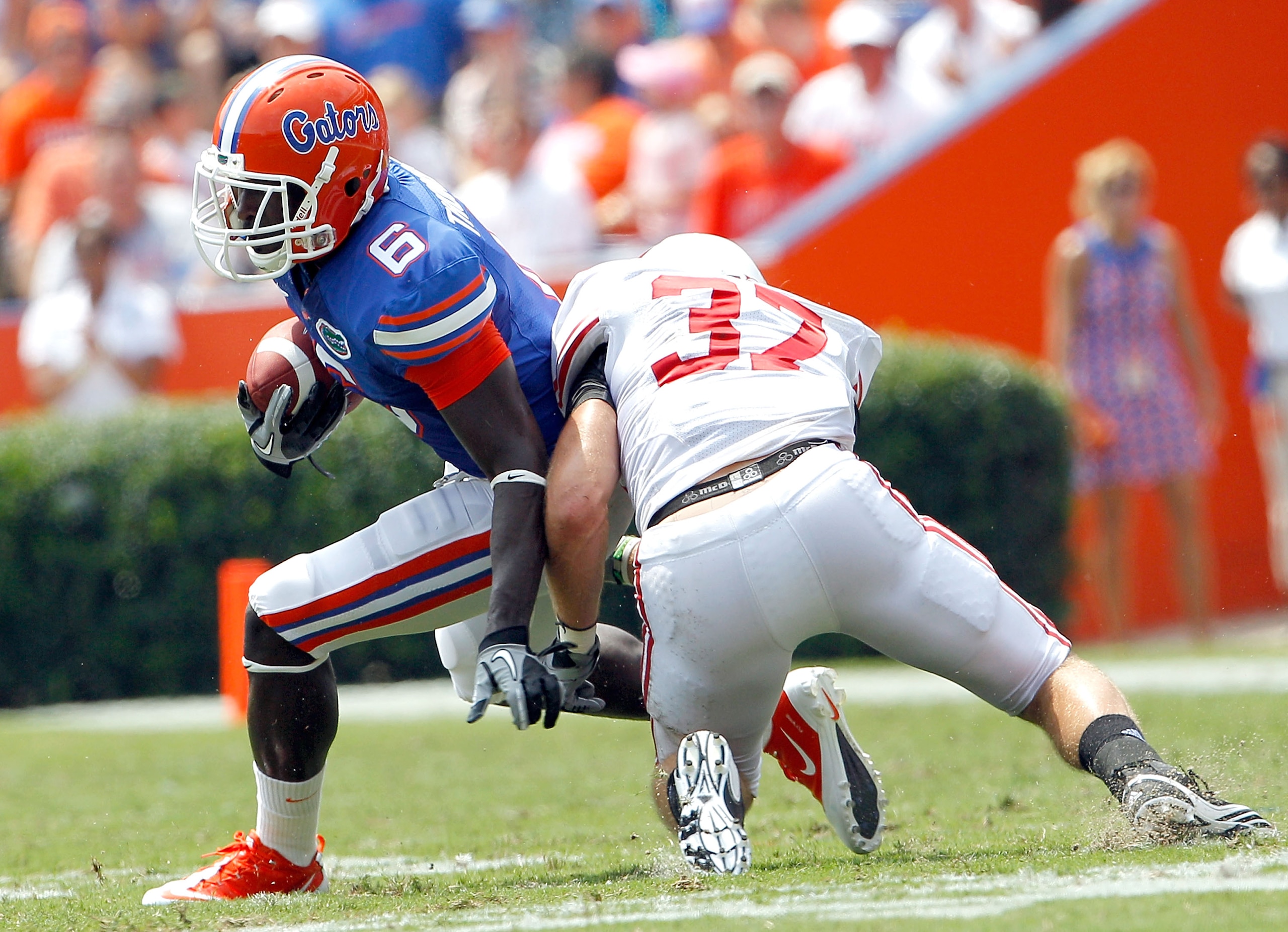 GAINESVILLE, FL - SEPTEMBER 04: Pat Hinkel #37 of the Miami University RedHawks attempts to tackle Deonte Thompson #6 of the Florida Gators at Ben Hill Griffin Stadium on September 4, 2010 in Gainesville, Florida. (Photo by Sam Greenwood/Getty Images) GAINESVILLE, FL - SEPTEMBER 04: Pat Hinkel #37 of the Miami University RedHawks attempts to tackle Deonte Thompson #6 of the Florida Gators at Ben Hill Griffin Stadium on September 4, 2010 in Gainesville, Florida. (Photo by Sam Greenwood/Getty Images)