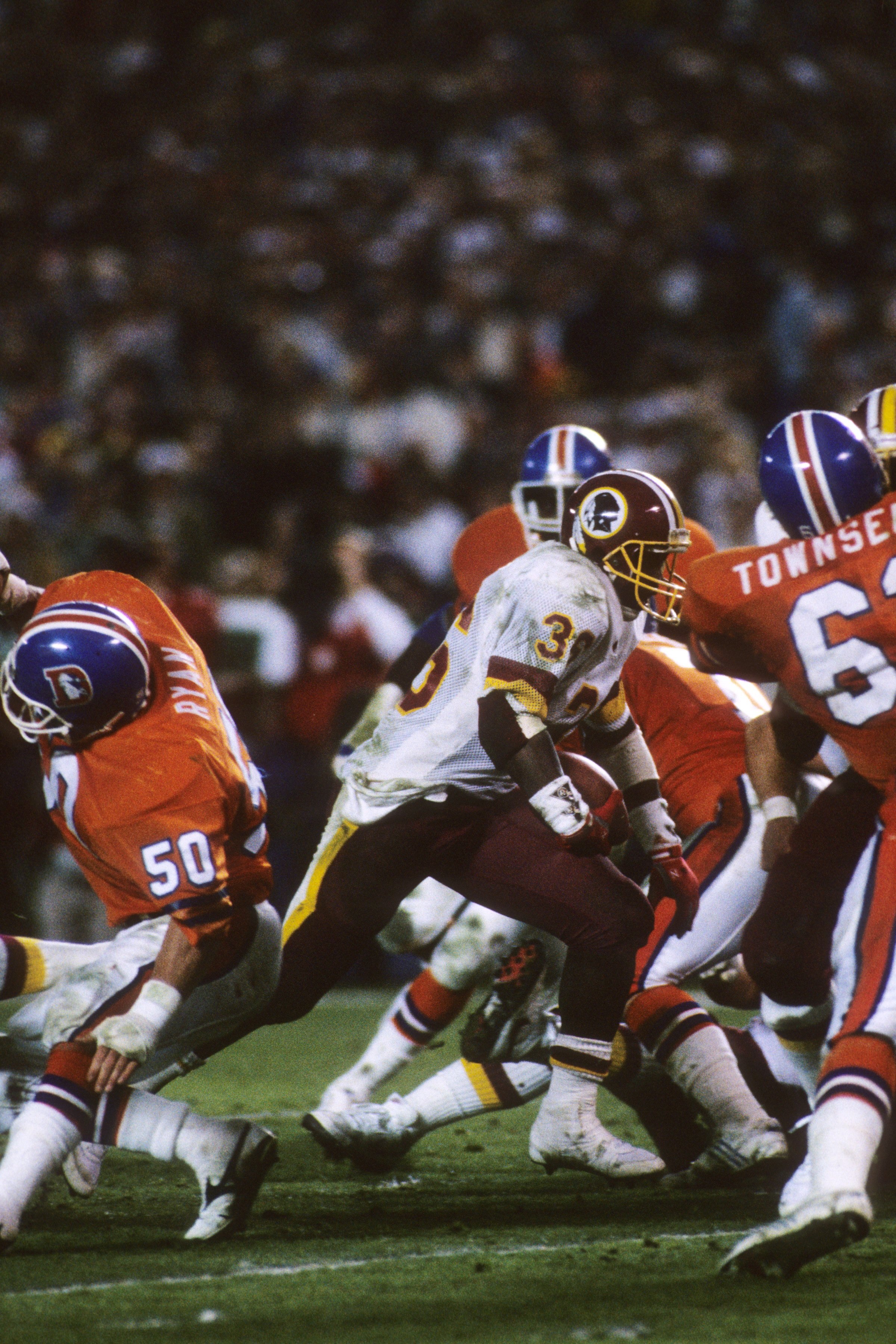 SAN DIEGO - JANUARY 31:  Running back Timmy Smith #36 of the Washington Redskins runs for a touchdown under pressure from the Denver Broncos during Super Bowl XXII at Jack Murphy Stadium on January 31, 1988 in San Diego, California.  The Redskins won 42-1
