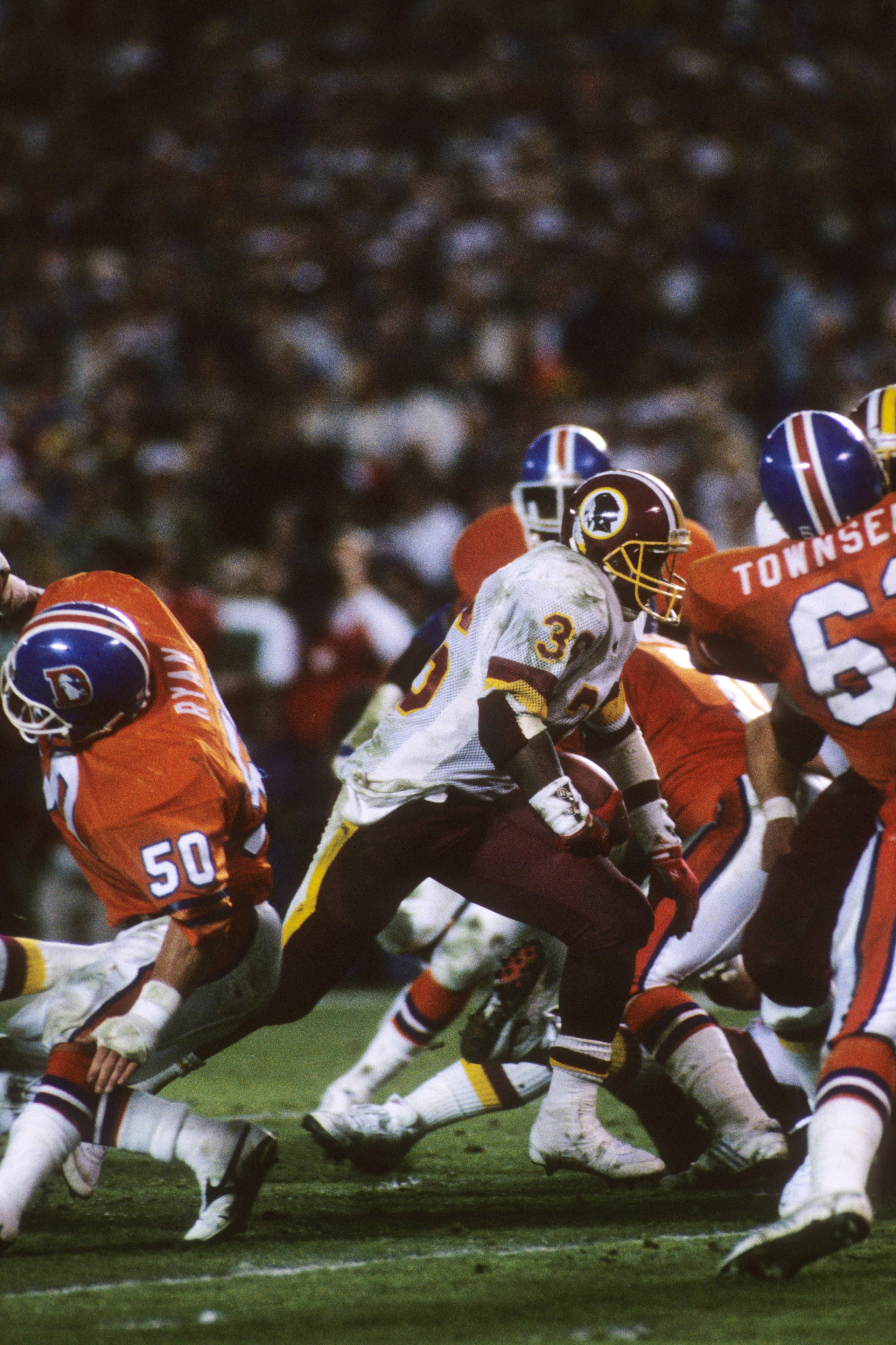 SAN DIEGO - JANUARY 31:  Running back Timmy Smith #36 of the Washington Redskins runs for a touchdown under pressure from the Denver Broncos during Super Bowl XXII at Jack Murphy Stadium on January 31, 1988 in San Diego, California.  The Redskins won 42-1
