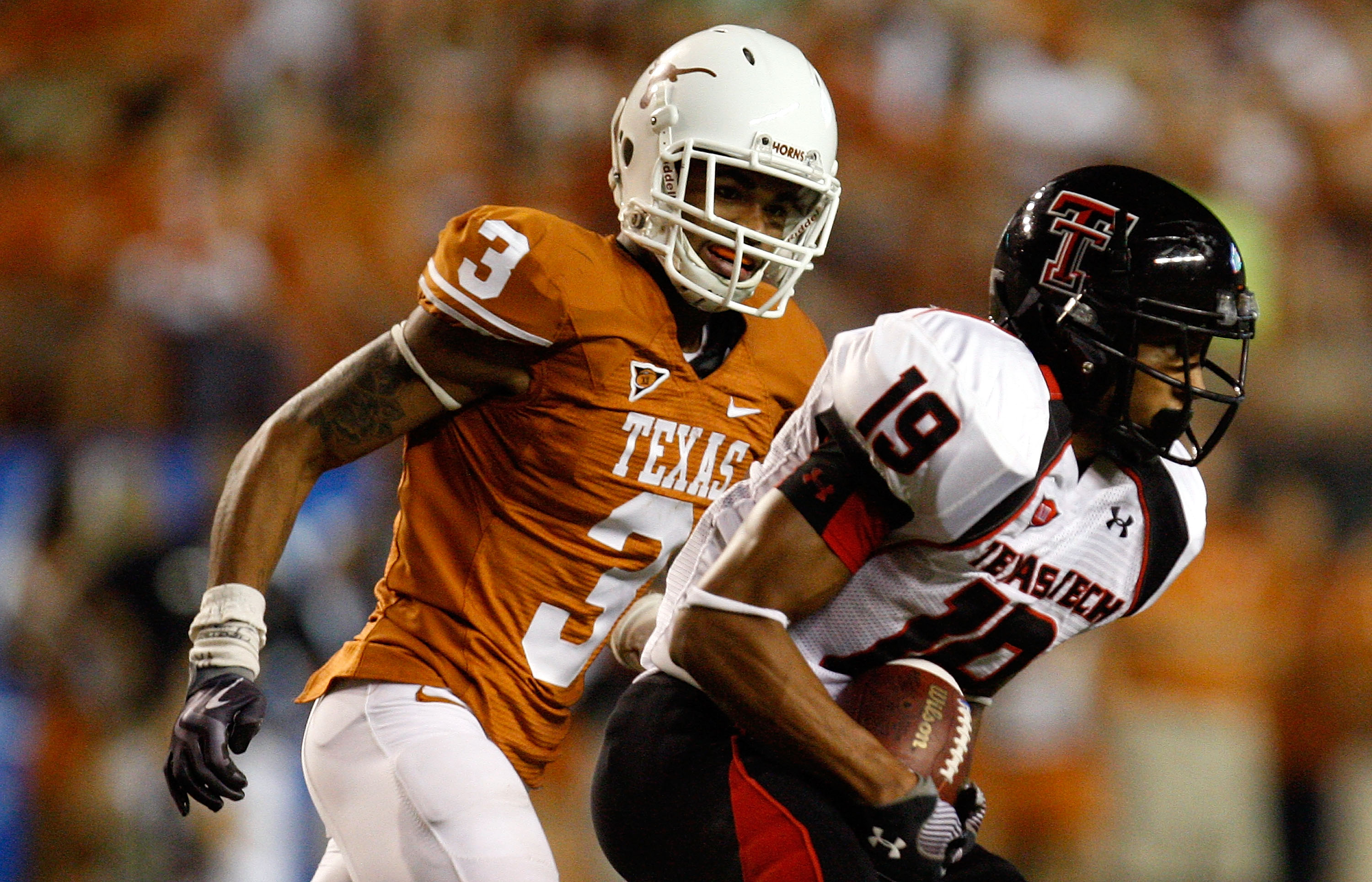 AUSTIN, TX - SEPTEMBER 19:  Wide receiver Lyle Leong #19 of the Texas Tech Red Raiders runs the ball past Curtis Brown #3 of the Texas Longhorns at Darrell K Royal-Texas Memorial Stadium on September 19, 2009 in Austin, Texas.  (Photo by Ronald Martinez/G