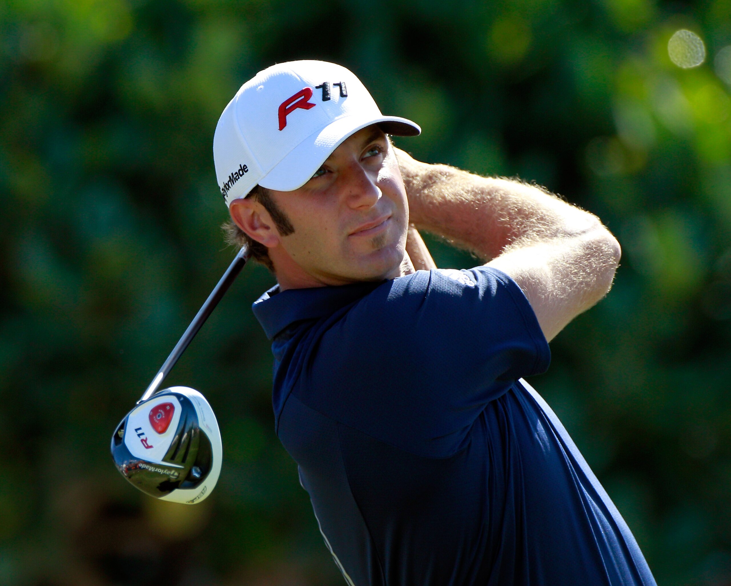 KAPALUA, HI - JANUARY 09:  Dustin Johnson hits a shot during the final round of the Hyundai Tournament of Champions at the Plantation course on January 9, 2011 in Kapalua, Hawaii.  (Photo by Sam Greenwood/Getty Images)