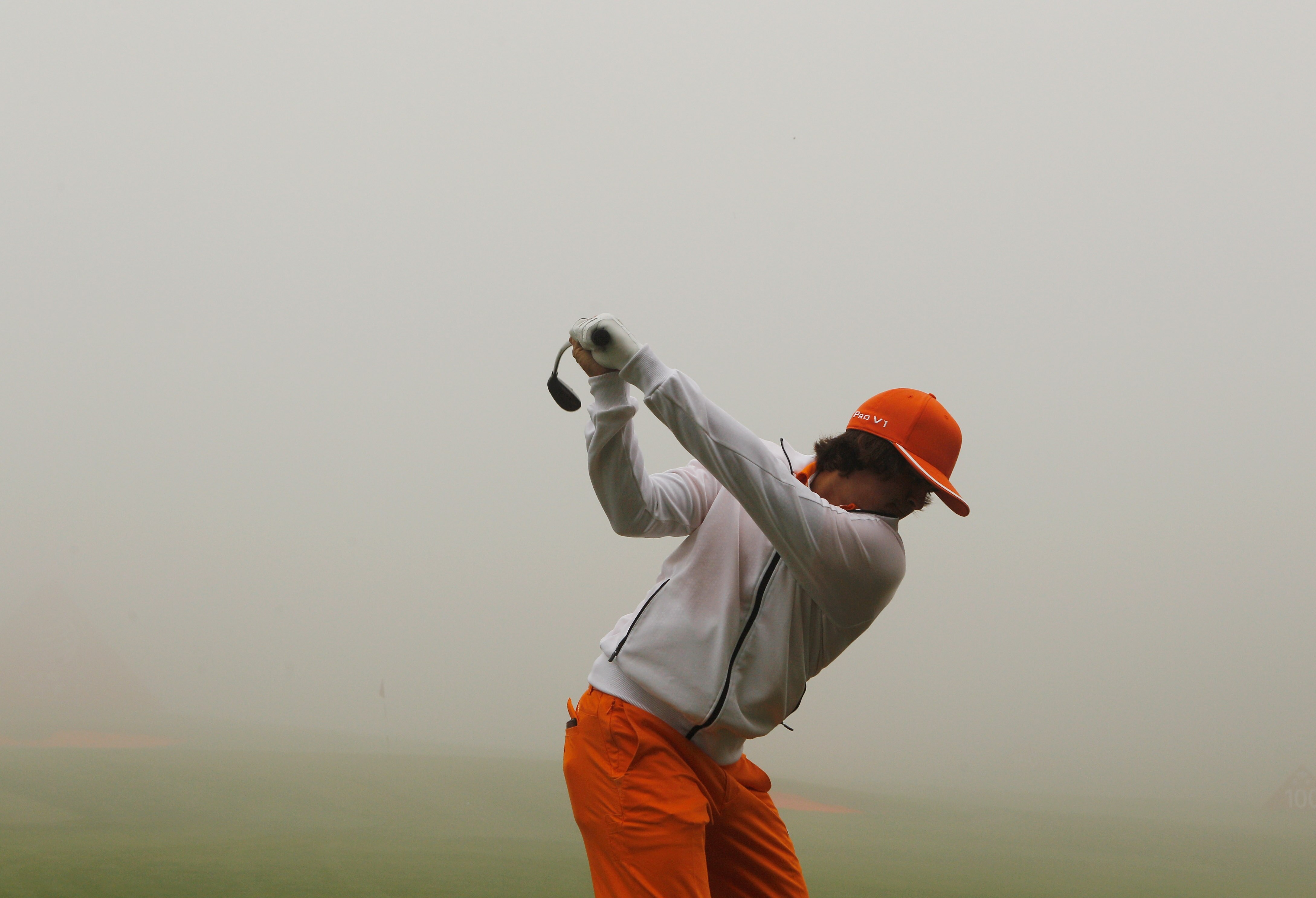 SHANGHAI, CHINA - NOVEMBER 07:  Rickie Fowler of the USA hits a shot on the practice ground during a fog delay in the final round of the HSBC Champions at the Sheshan Golf Club on November 7, 2010 in Shanghai, China.  (Photo by Scott Halleran/Getty Images