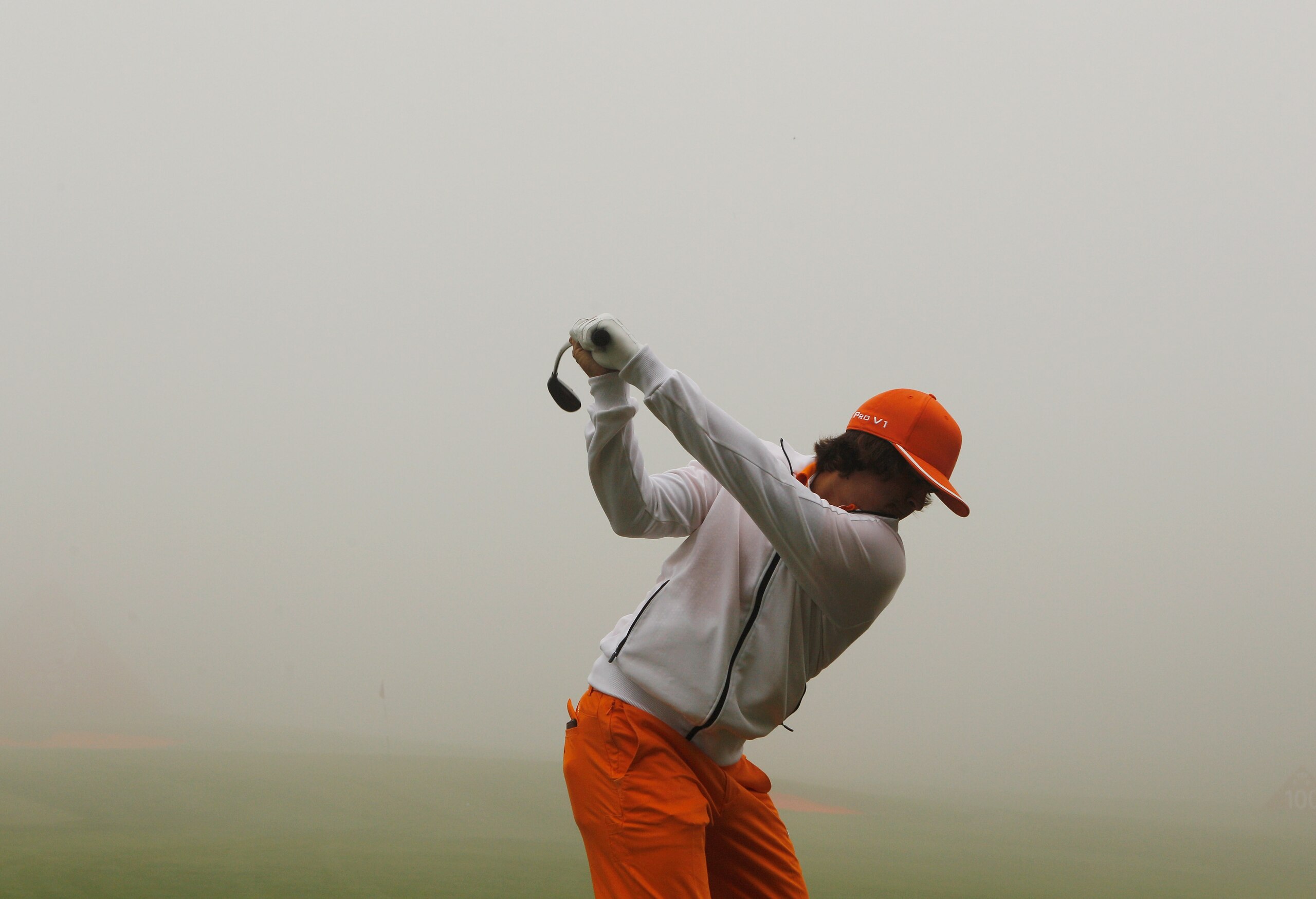 SHANGHAI, CHINA - NOVEMBER 07:  Rickie Fowler of the USA hits a shot on the practice ground during a fog delay in the final round of the HSBC Champions at the Sheshan Golf Club on November 7, 2010 in Shanghai, China.  (Photo by Scott Halleran/Getty Images