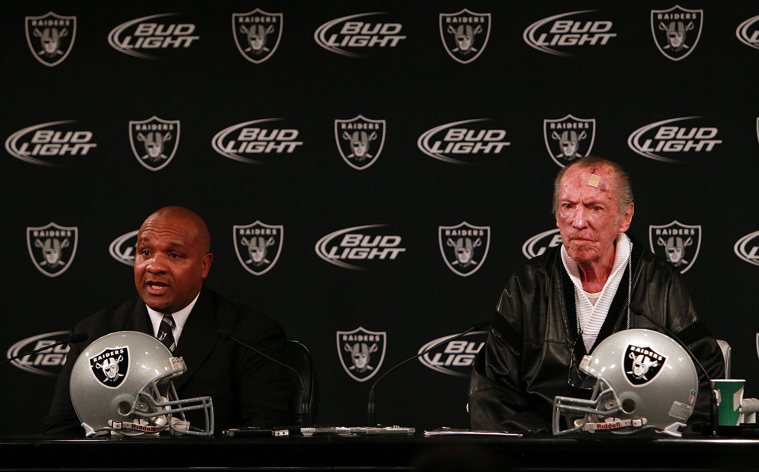ALAMEDA, CA - JANUARY 18:  New Oakland Raiders coach Hue Jackson (L) speaks to reporters with Raiders owner Al Davis (R) during a press conference on January 18, 2011 in Alameda, California.  Hue Jackson was introduced as the new coach of the Oakland Raid