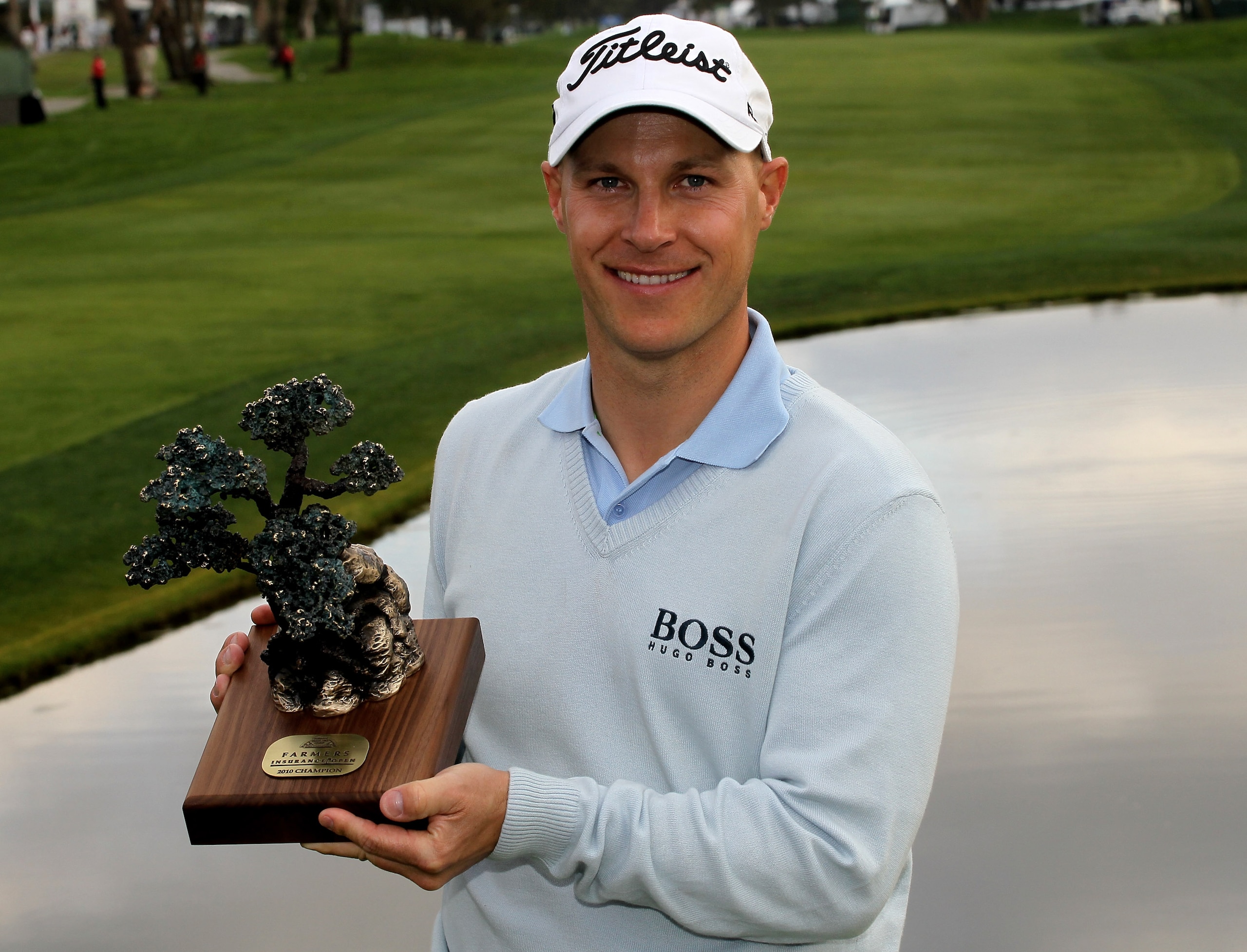 LA JOLLA, CA - JANUARY 31:  Ben Crane poses with the trophy on the 18th green on the South Course at Torrey Pines Golf Course after the final round of the Farmers Insurance Open on January 31, 2010 in La Jolla, California. (Photo by Stephen Dunn/Getty Ima