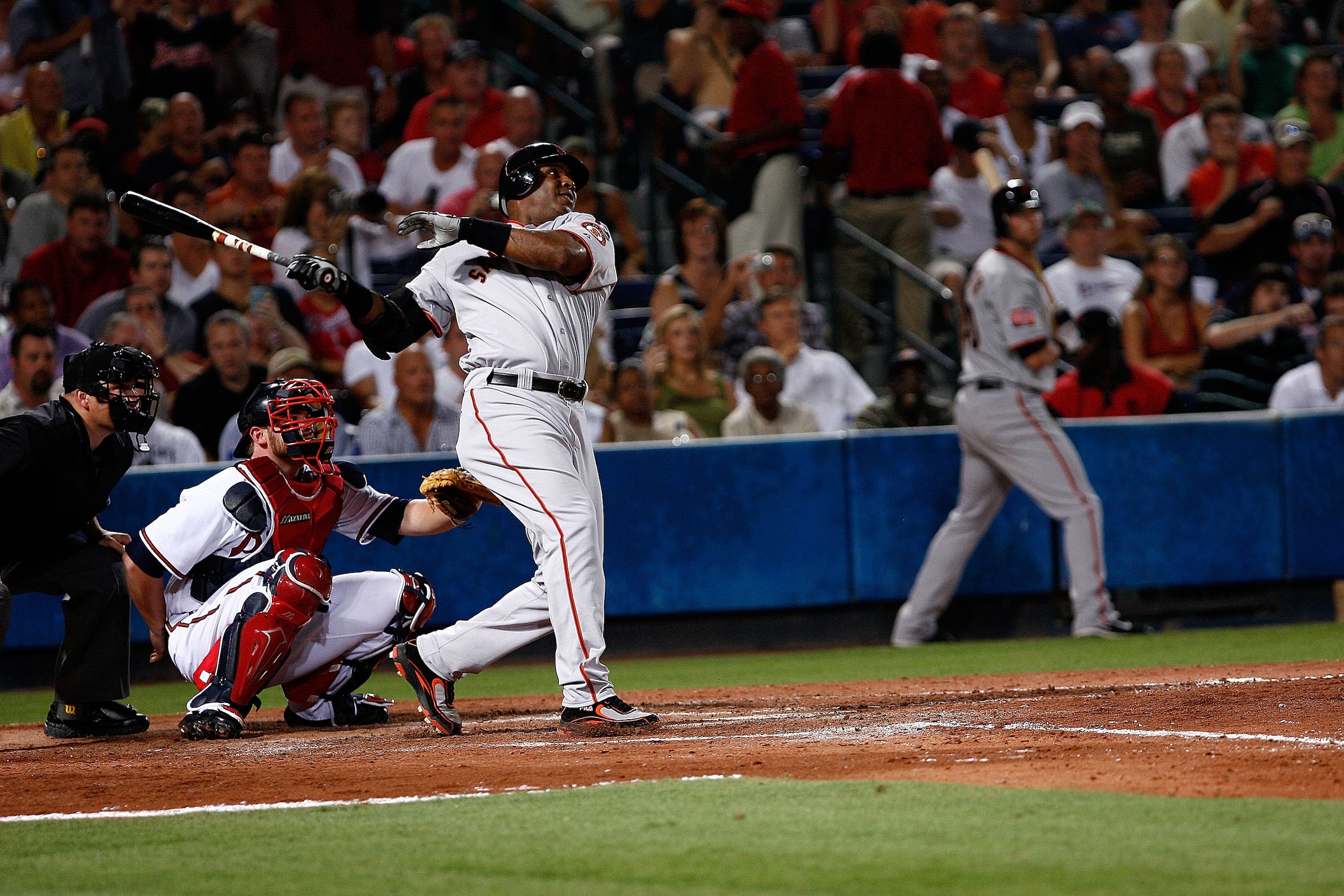 ATLANTA - AUGUST 15: Barry Bonds #25 of the San Francisco Giants follows through on his swing during home run #759 of his career while Atlanta Braves catcher Brian McCann #16 and home plate umpire Mark Carlson look on during the game between San Francisco