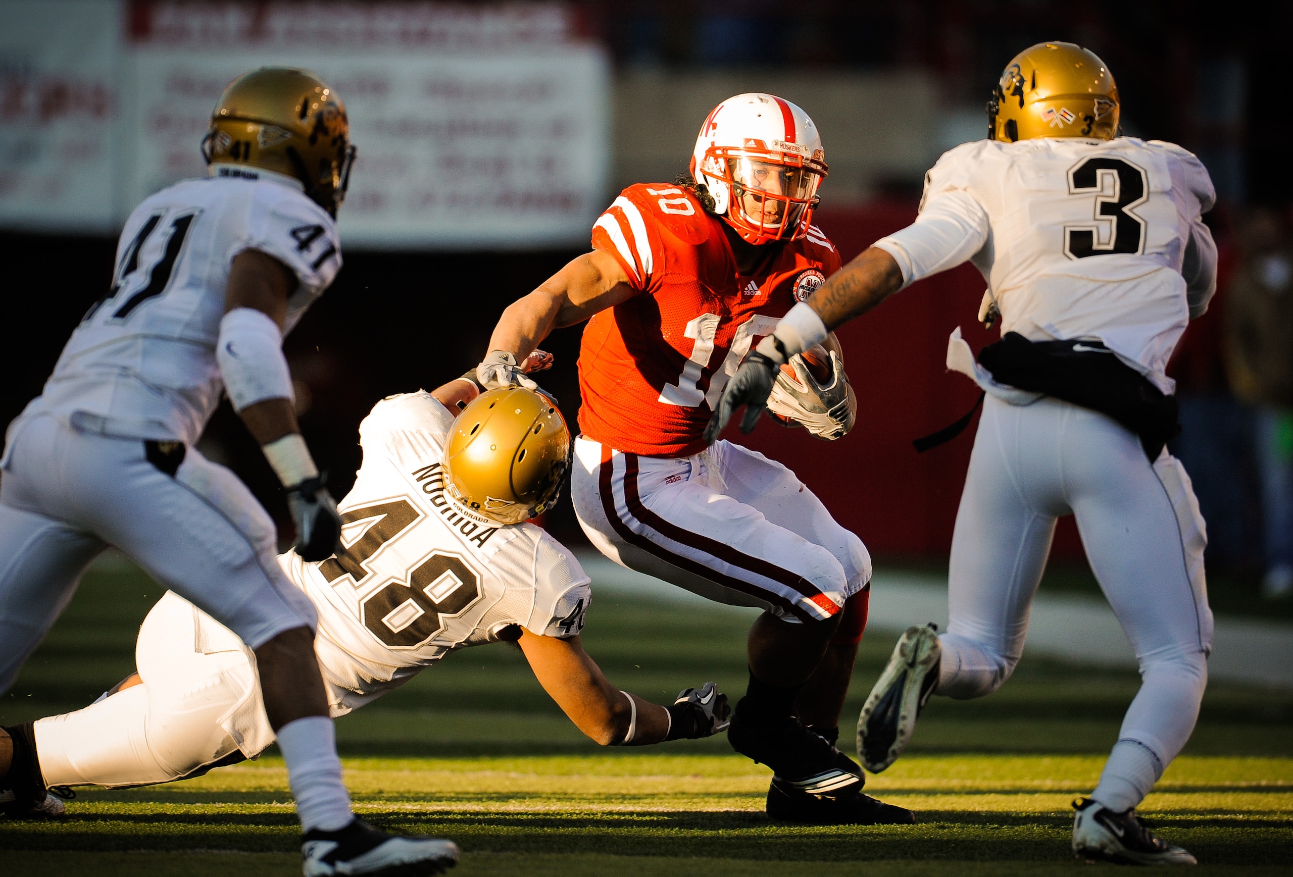 LINCOLN, NE - NOVEMBER 26: Roy Helu Jr. #10 of the Nebraska Cornhuskers slips past Liloa Nobriga #48 of the Colorado Buffaloes during their game at Memorial Stadium on November 26, 2010 in Lincoln, Nebraska. Nebraska defeated Colorado 45-17 (Photo by Eric LINCOLN, NE - NOVEMBER 26: Roy Helu Jr. #10 of the Nebraska Cornhuskers slips past Liloa Nobriga #48 of the Colorado Buffaloes during their game at Memorial Stadium on November 26, 2010 in Lincoln, Nebraska. Nebraska defeated Colorado 45-17 (Photo by Eric