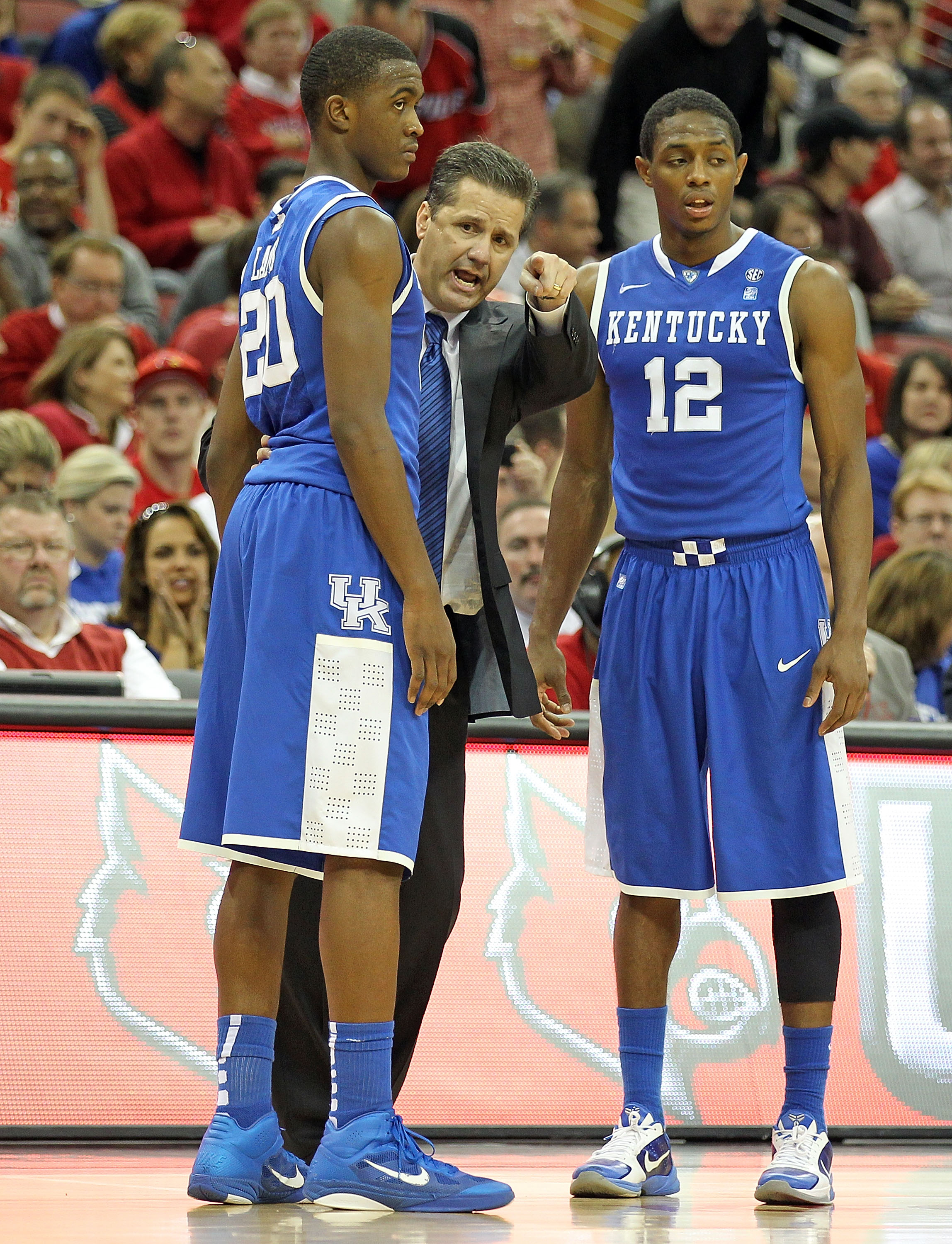 LOUISVILLE, KY - DECEMBER 31: John Calipari the Head Coach of the Kentucky Wildcats gives instructions to Doron Lamb #20 and Brandon Knight #12 during the game against the Louisville Cardinals at the KFC Yum! Center on December 31, 2010 in Louisville, Ken