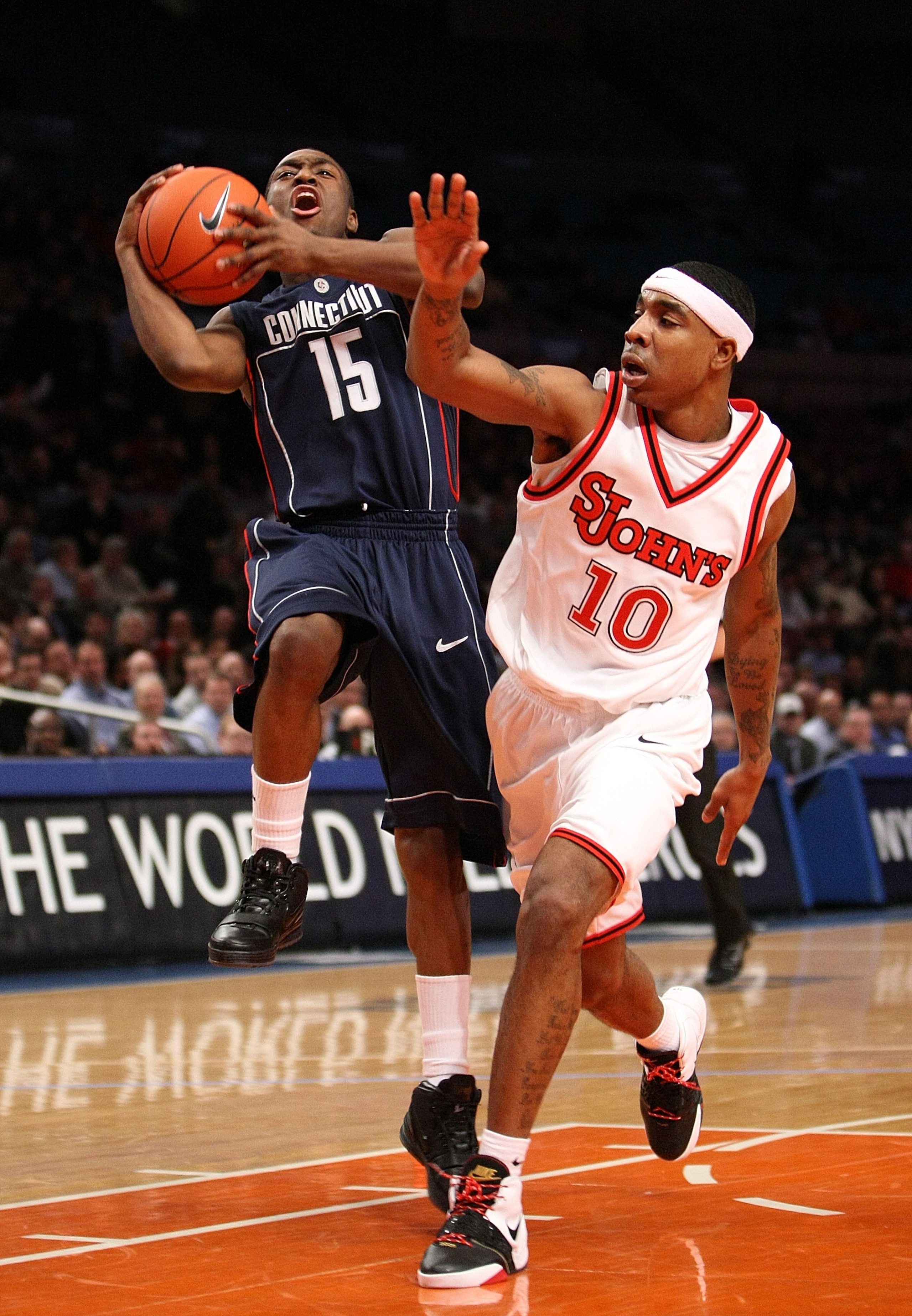 NEW YORK - JANUARY 15:  Kemba Walker #15 of the Connecticut Huskies is fouled by Quincy Roberts #10 of the St. John's Red Storm on January 15, 2009 at Madison Square Garden in New York City.  (Photo by Nick Laham/Getty Images)
