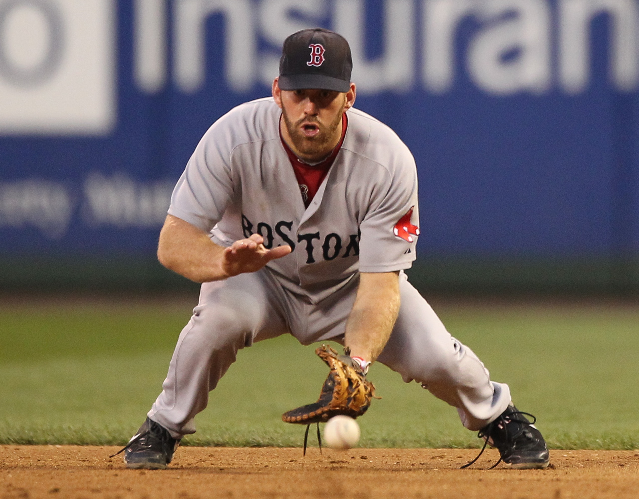 SEATTLE - JULY 23: Kevin Youkilis #20 of the Boston Red Sox fields a ground ball by Milton Bradley of the Seattle Mariners at Safeco Field on July 23, 2010 in Seattle, Washington. (Photo by Otto Greule Jr/Getty Images)