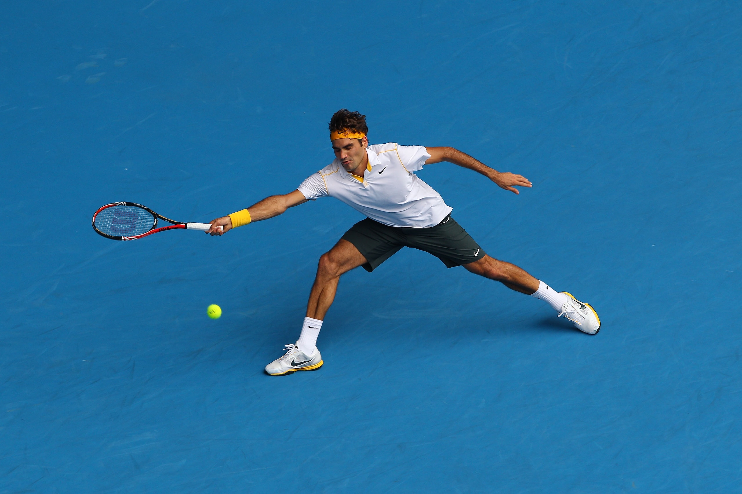 MELBOURNE, AUSTRALIA - JANUARY 25: Roger Federer of Switzerland plays a forehand in his quarterfinal match against Stanislas Wawrinka of Switzerland during day nine of the 2011 Australian Open at Melbourne Park on January 25, 2011 in Melbourne, Australia MELBOURNE, AUSTRALIA - JANUARY 25: Roger Federer of Switzerland plays a forehand in his quarterfinal match against Stanislas Wawrinka of Switzerland during day nine of the 2011 Australian Open at Melbourne Park on January 25, 2011 in Melbourne, Australia