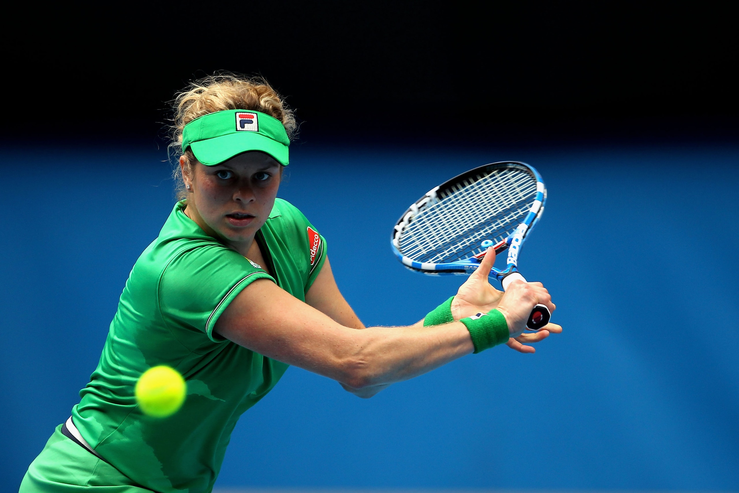 MELBOURNE, AUSTRALIA - JANUARY 26: Kim Clijsters of Belgium plays a backhand in her quarterfinal match against Agnieszka Radwanska of Poland during day ten of the 2011 Australian Open at Melbourne Park on January 26, 2011 in Melbourne, Australia. (Photo MELBOURNE, AUSTRALIA - JANUARY 26: Kim Clijsters of Belgium plays a backhand in her quarterfinal match against Agnieszka Radwanska of Poland during day ten of the 2011 Australian Open at Melbourne Park on January 26, 2011 in Melbourne, Australia. (Photo