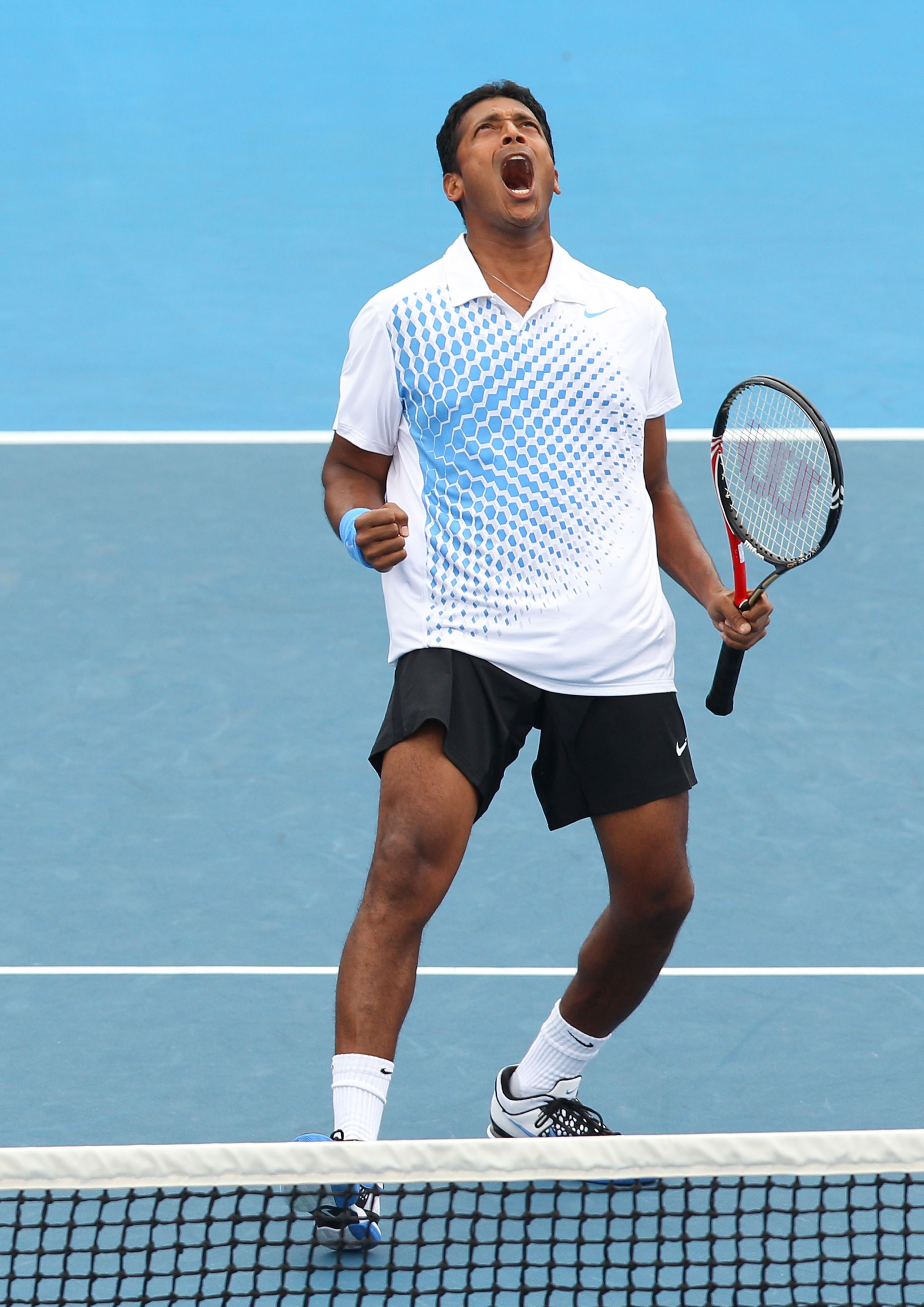 MELBOURNE, AUSTRALIA - JANUARY 26:  Leander Paes of India celebrates in his fourth round doubles match with Mahesh Bhupati of India in their match against Michael Llodra of France and Nenad Zimonjic of Serbia during day ten of the 2011 Australian Open at