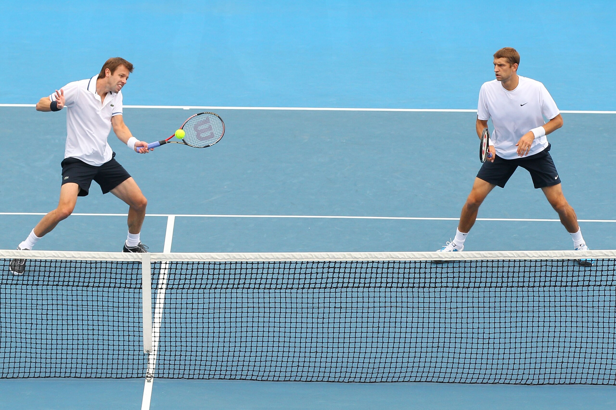 MELBOURNE, AUSTRALIA - JANUARY 26:  Daniel Nestor of Canada plays a forehand in his fourth round doubles match with partner Max Mirnyi of Bulgaria against Mariusz Frystenberg of Poland and Marcin Matkowski of Poland during day ten of the 2011 Australian O