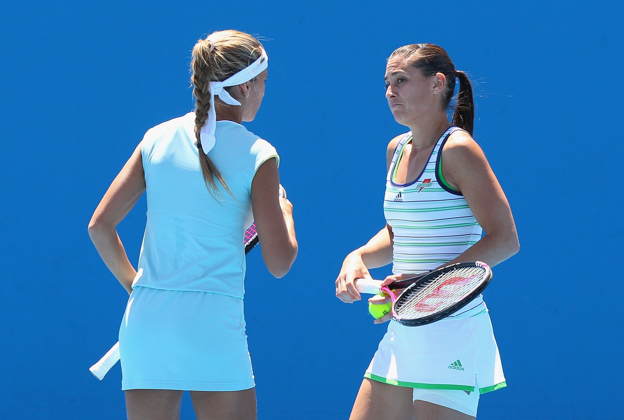 MELBOURNE, AUSTRALIA - JANUARY 19:  Flavia Pennetta of Italy and Gisela Dulko of Argentina talk tactics during their first round doubles match against Renata Voracova of Czech Republic and Sania Mirza of India during day three of the 2011 Australian Open