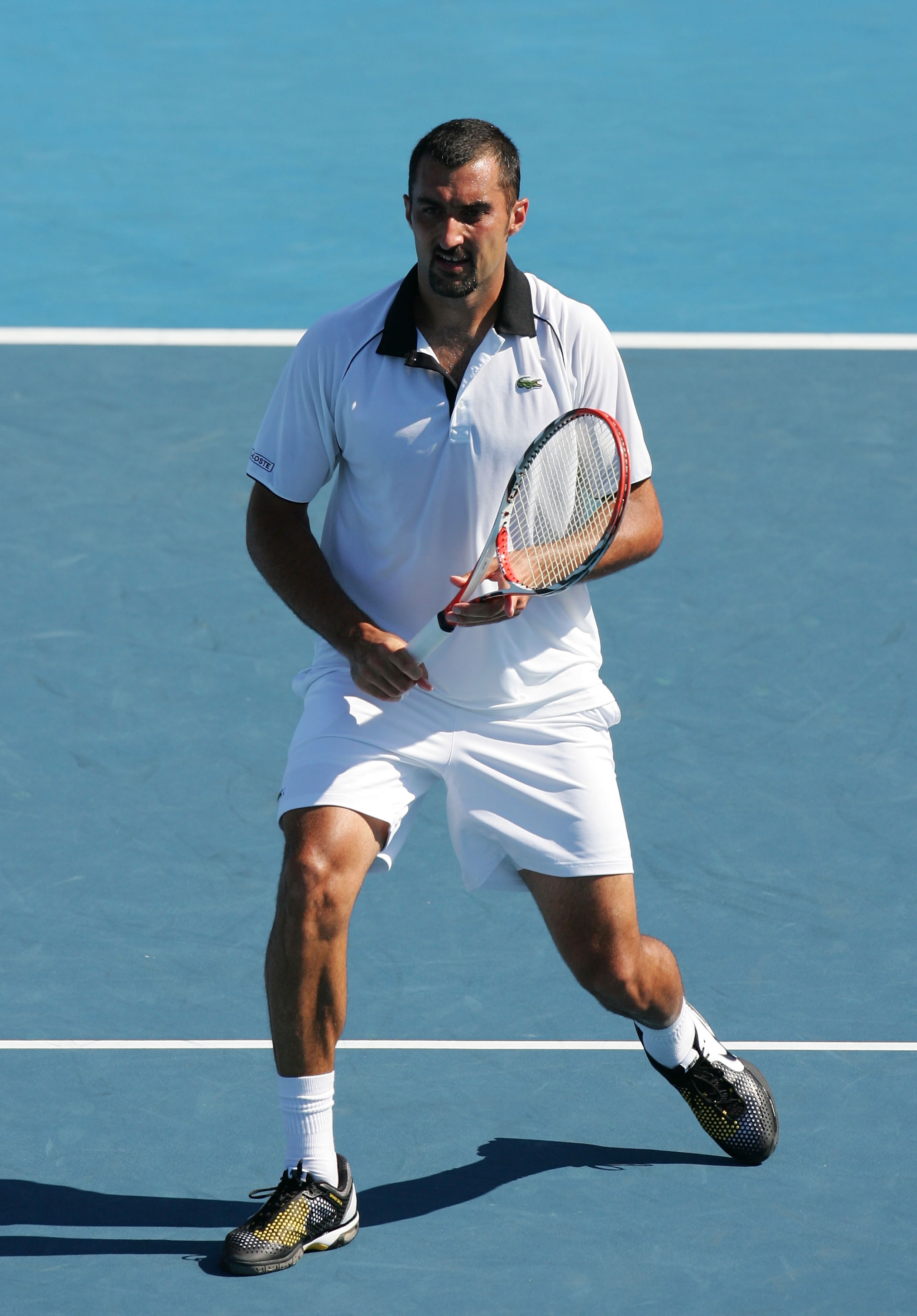 MELBOURNE, AUSTRALIA - JANUARY 23: Nenad Zimonjic of Serbia celebrates in her first round mixed doubles match with partner  Maria Kirilenko of Russia against Zi Yan of China and Ruhan Bopanna of India during day seven of the 2011 Australian Open at Melbou