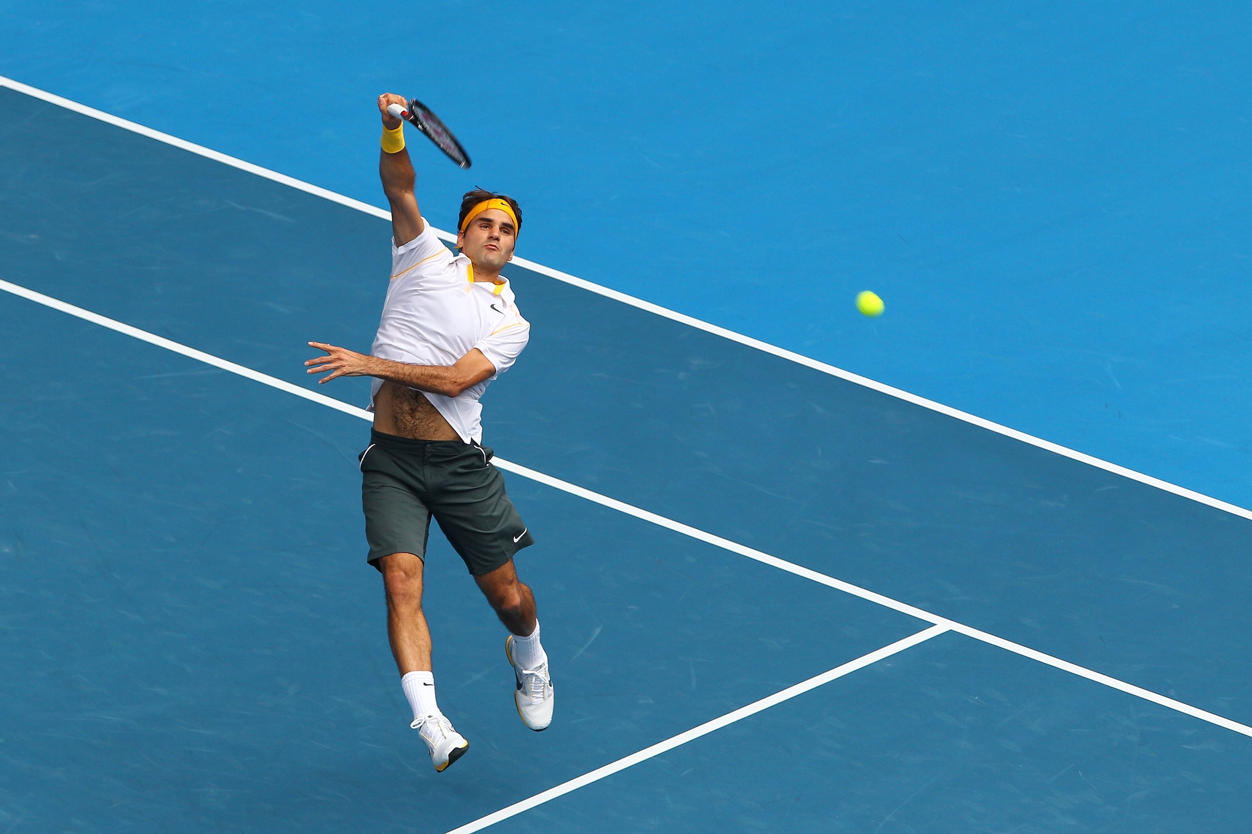 MELBOURNE, AUSTRALIA - JANUARY 25:  Roger Federer of Switzerland serves in his quarterfinal match against Stanislas Wawrinka of Switzerland during day nine of the 2011 Australian Open at Melbourne Park on January 25, 2011 in Melbourne, Australia.  (Photo