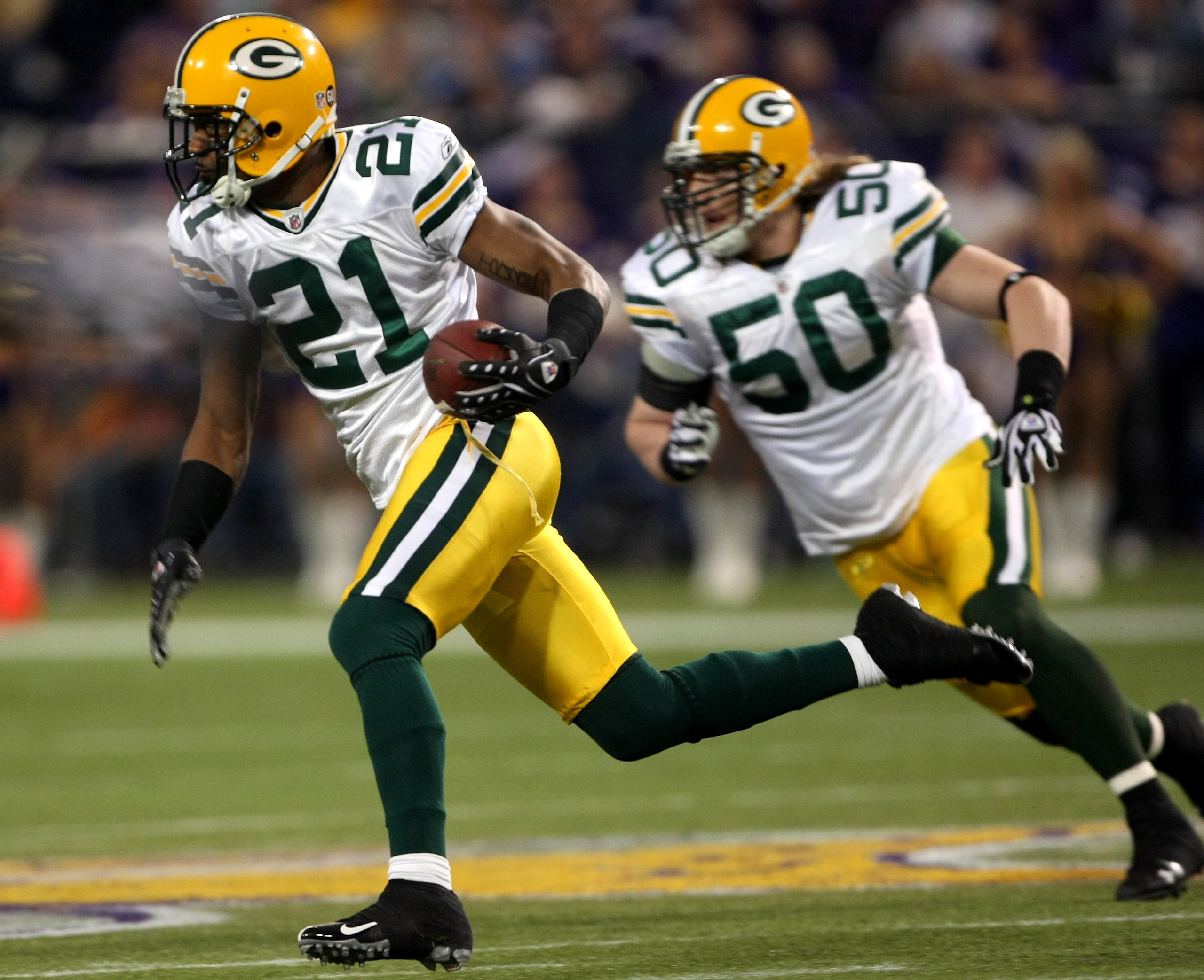 MINNEAPOLIS - NOVEMBER 09: Cornerback Charles Woodson #21 of the Green Bay Packers returns an interception as linebacker A.J. Hawk blocks against the Minnesota Vikings on November 9, 2008 at the Metrodome in Mineapolis, Minnesota. (Photo by Stephen Dunn/ MINNEAPOLIS - NOVEMBER 09: Cornerback Charles Woodson #21 of the Green Bay Packers returns an interception as linebacker A.J. Hawk blocks against the Minnesota Vikings on November 9, 2008 at the Metrodome in Mineapolis, Minnesota. (Photo by Stephen Dunn/