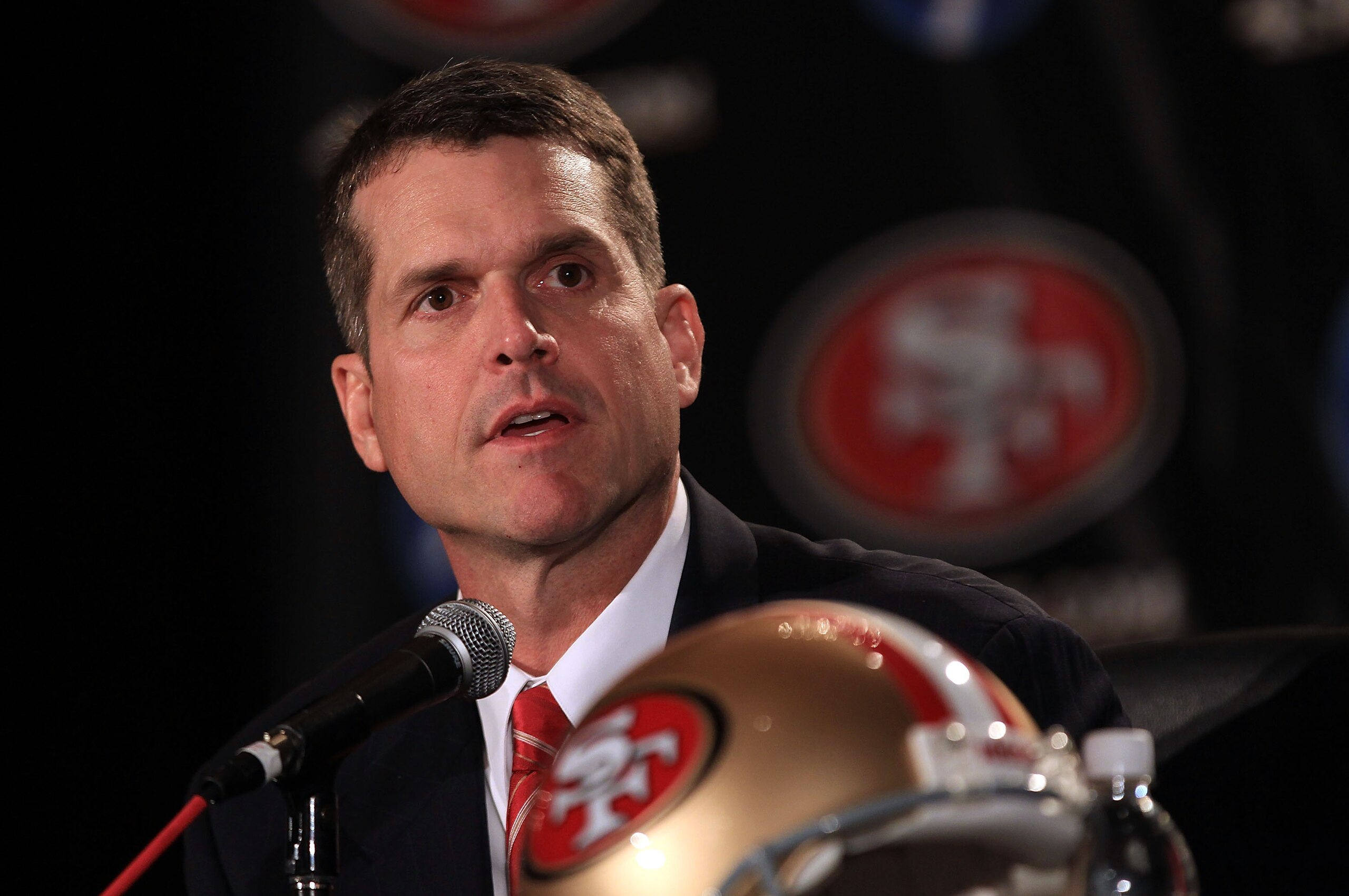 SAN FRANCISCO, CA - JANUARY 07: Jim Harbaugh speaks at a press conference where he was introduced as the new San Francisco 49ers head coach at the Palace Hotel on January 7, 2011 in San Francisco, California. (Photo by Ezra Shaw/Getty Images) SAN FRANCISCO, CA - JANUARY 07: Jim Harbaugh speaks at a press conference where he was introduced as the new San Francisco 49ers head coach at the Palace Hotel on January 7, 2011 in San Francisco, California. (Photo by Ezra Shaw/Getty Images)
