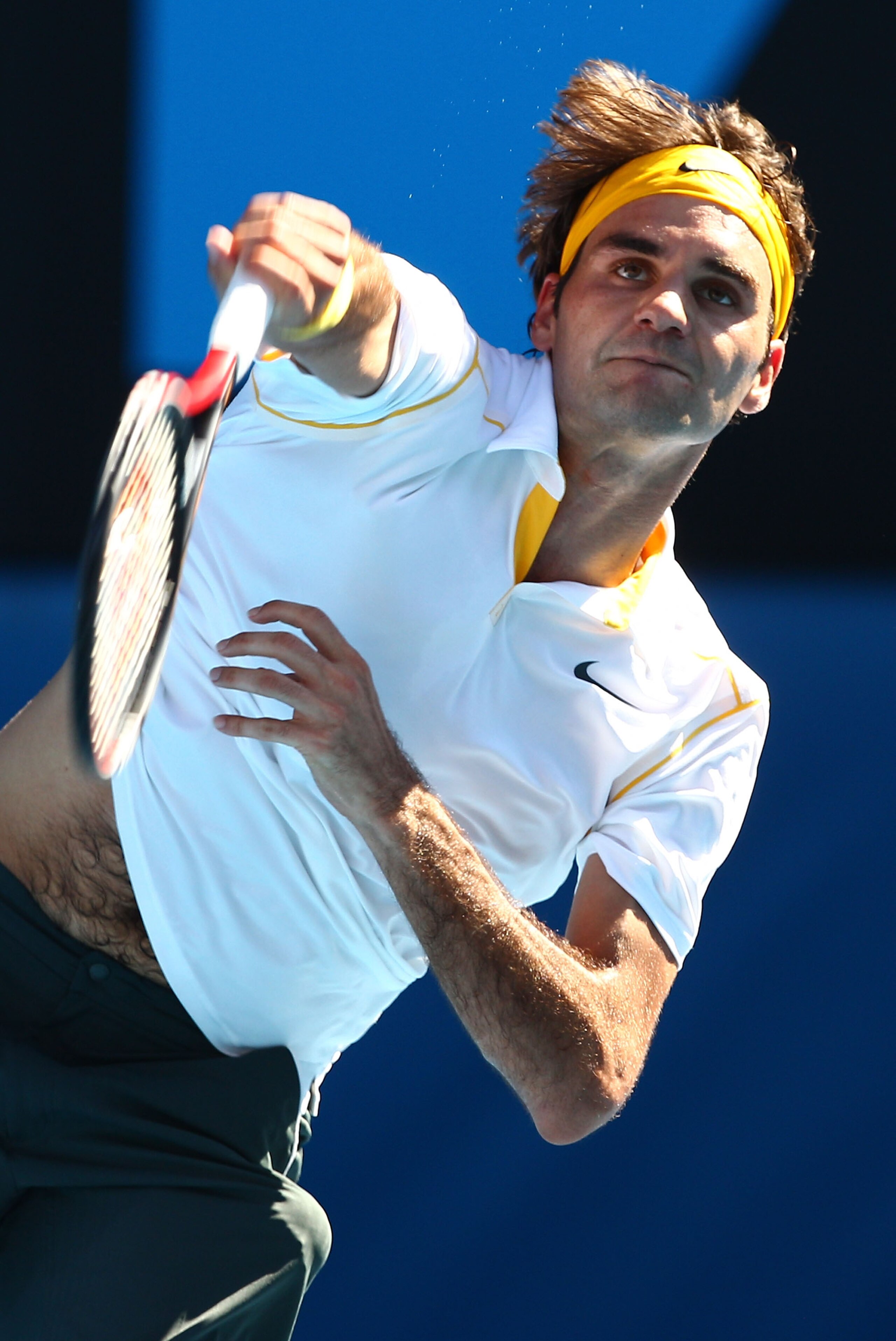 MELBOURNE, AUSTRALIA - JANUARY 23: Roger Federer of Switzerland serves in his fourth round match against Tommy Robredo of Spain during day seven of the 2011 Australian Open at Melbourne Park on January 23, 2011 in Melbourne, Australia. (Photo by Cameron MELBOURNE, AUSTRALIA - JANUARY 23: Roger Federer of Switzerland serves in his fourth round match against Tommy Robredo of Spain during day seven of the 2011 Australian Open at Melbourne Park on January 23, 2011 in Melbourne, Australia. (Photo by Cameron