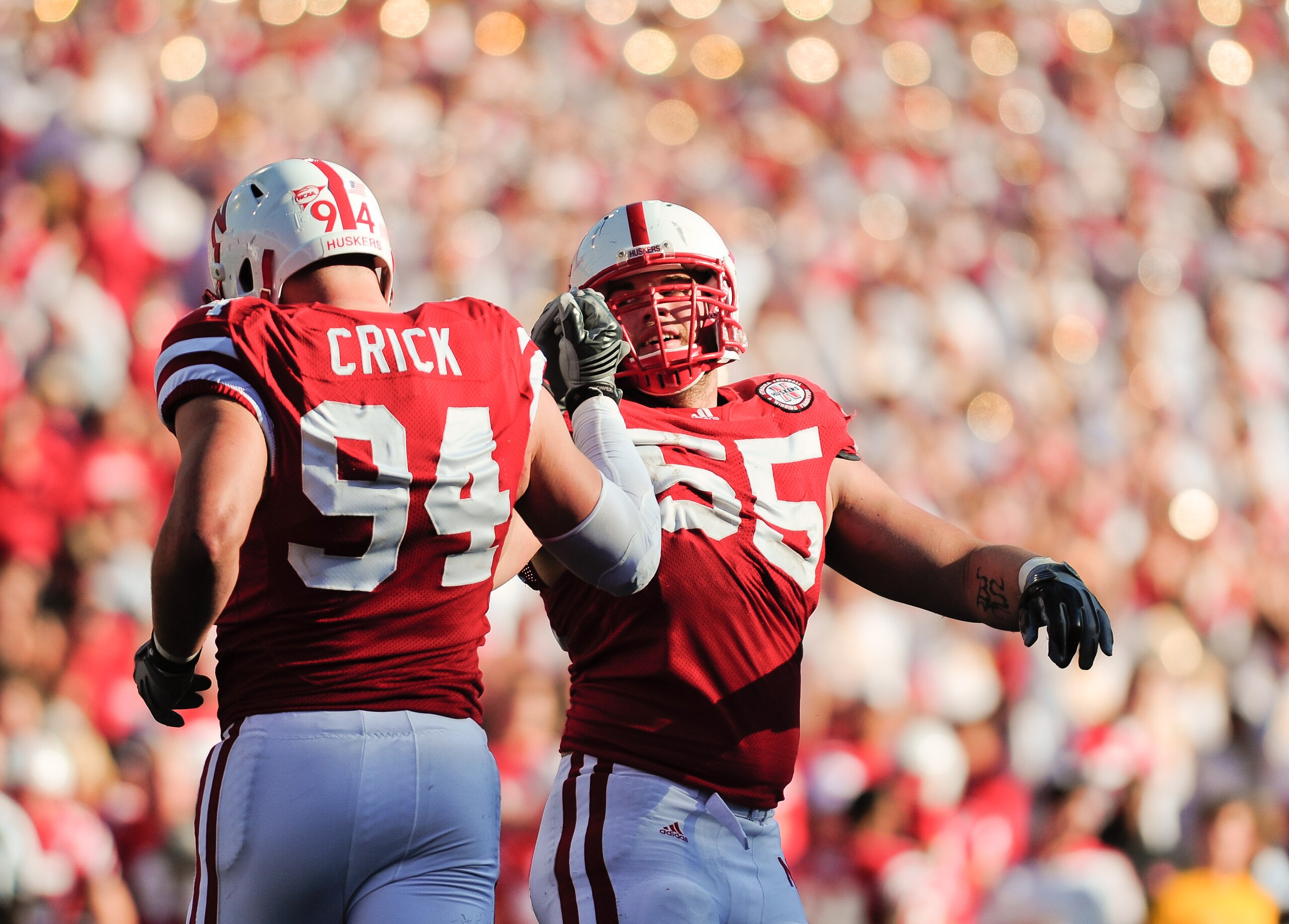 LINCOLN, NE - OCTOBER 30: Defensive tackle Baker Steinkuhler #55  of the Nebraska Cornhuskers high fives teammate  defensive tackle Jared Crick #94 after a third down stop during second half action of their game at Memorial Stadium on October 30, 2010 in