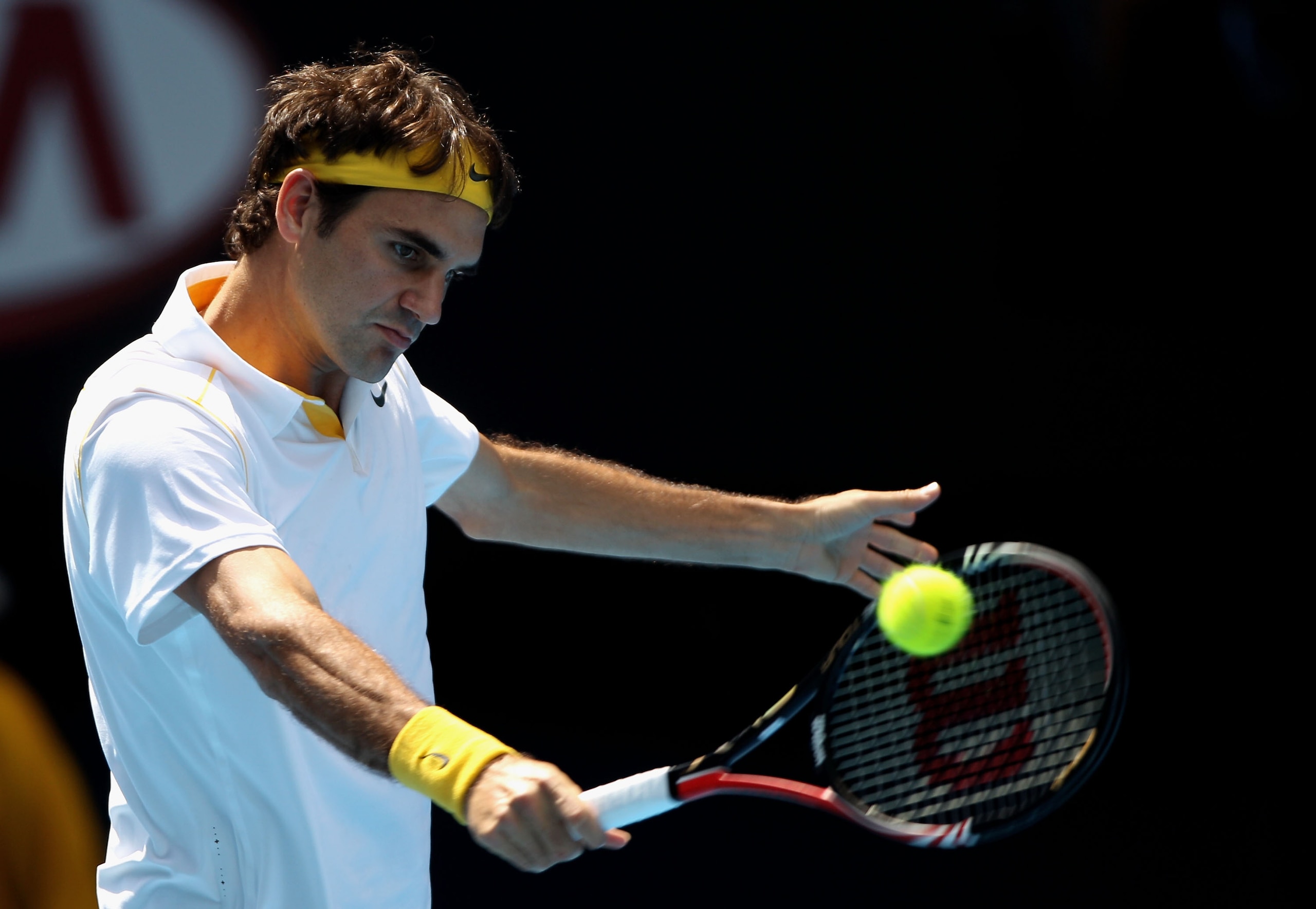 MELBOURNE, AUSTRALIA - JANUARY 21: Roger Federer of Switzerland plays a backhand in his third round match against Xavier Malisse of Belgium during day five of the 2011 Australian Open at Melbourne Park on January 21, 2011 in Melbourne, Australia. (Photo MELBOURNE, AUSTRALIA - JANUARY 21: Roger Federer of Switzerland plays a backhand in his third round match against Xavier Malisse of Belgium during day five of the 2011 Australian Open at Melbourne Park on January 21, 2011 in Melbourne, Australia. (Photo