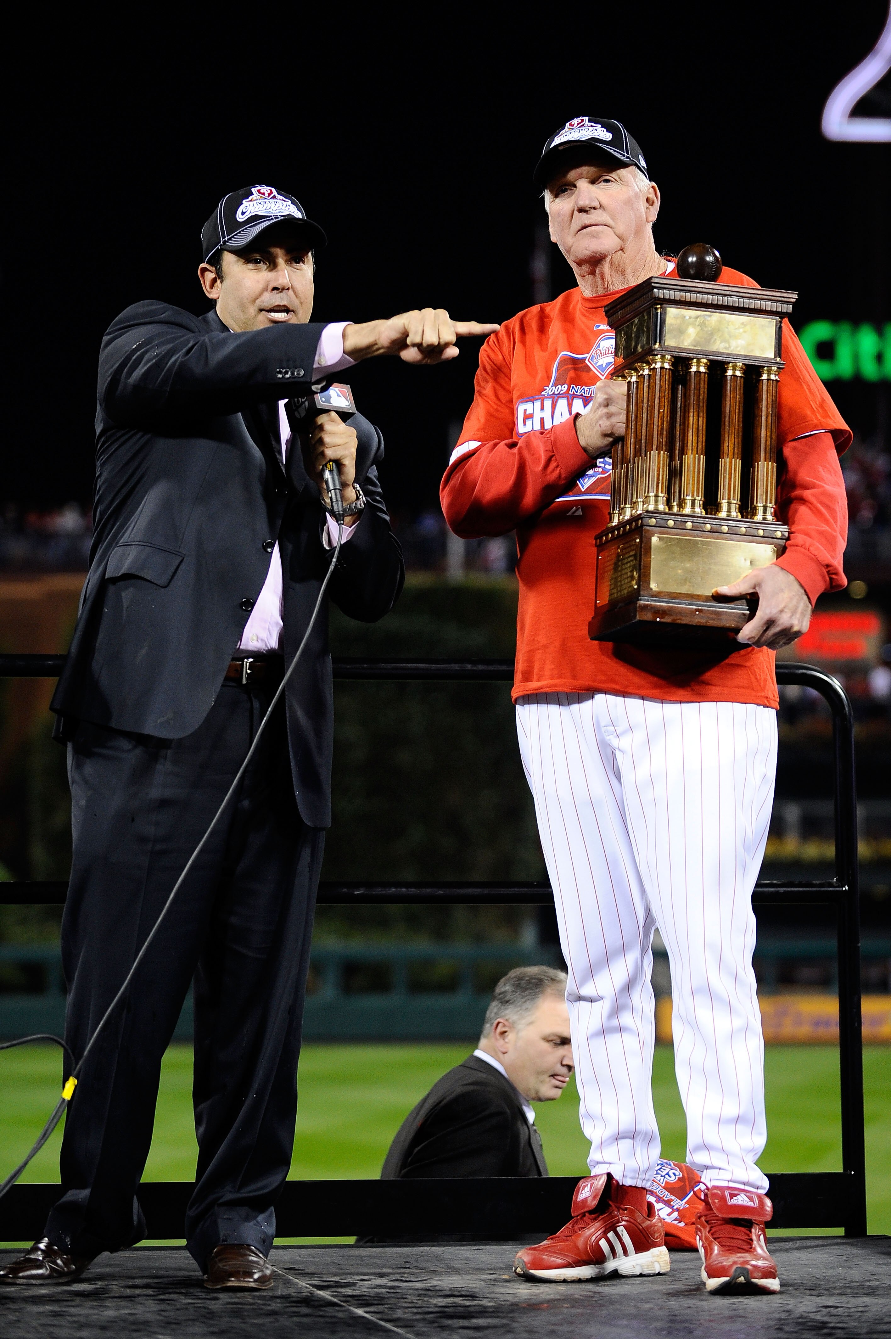 PHILADELPHIA - OCTOBER 21:  Manager Charlie Manuel of the Philadelphia Phillies halds the trophy with Phillies GM Ruben Amaro Jr. as they celebrate defeating the Los Angeles Dodgers 10-4 to advance to the World Series in Game Five of the NLCS during the 2