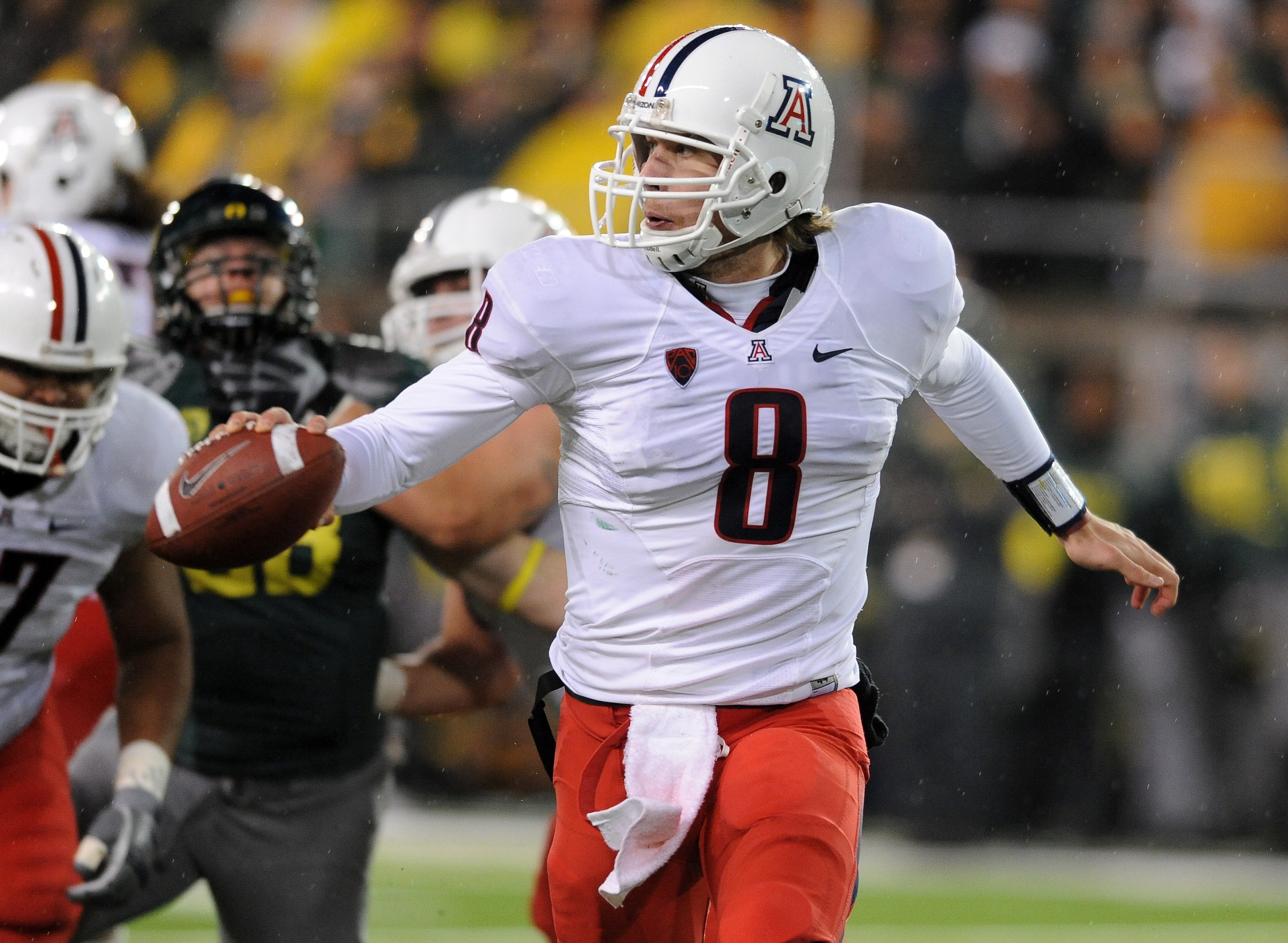 EUGENE, OR - NOVEMBER 26: Quarterback Nick Foles #8 of the Arizona Wildcats looks for someone to flip the ball to in the fourth quarter of the game at against the Oregon Ducks at Autzen Stadium on November 26, 2010 in Eugene, Oregon. The Ducks won the gam EUGENE, OR - NOVEMBER 26: Quarterback Nick Foles #8 of the Arizona Wildcats looks for someone to flip the ball to in the fourth quarter of the game at against the Oregon Ducks at Autzen Stadium on November 26, 2010 in Eugene, Oregon. The Ducks won the gam