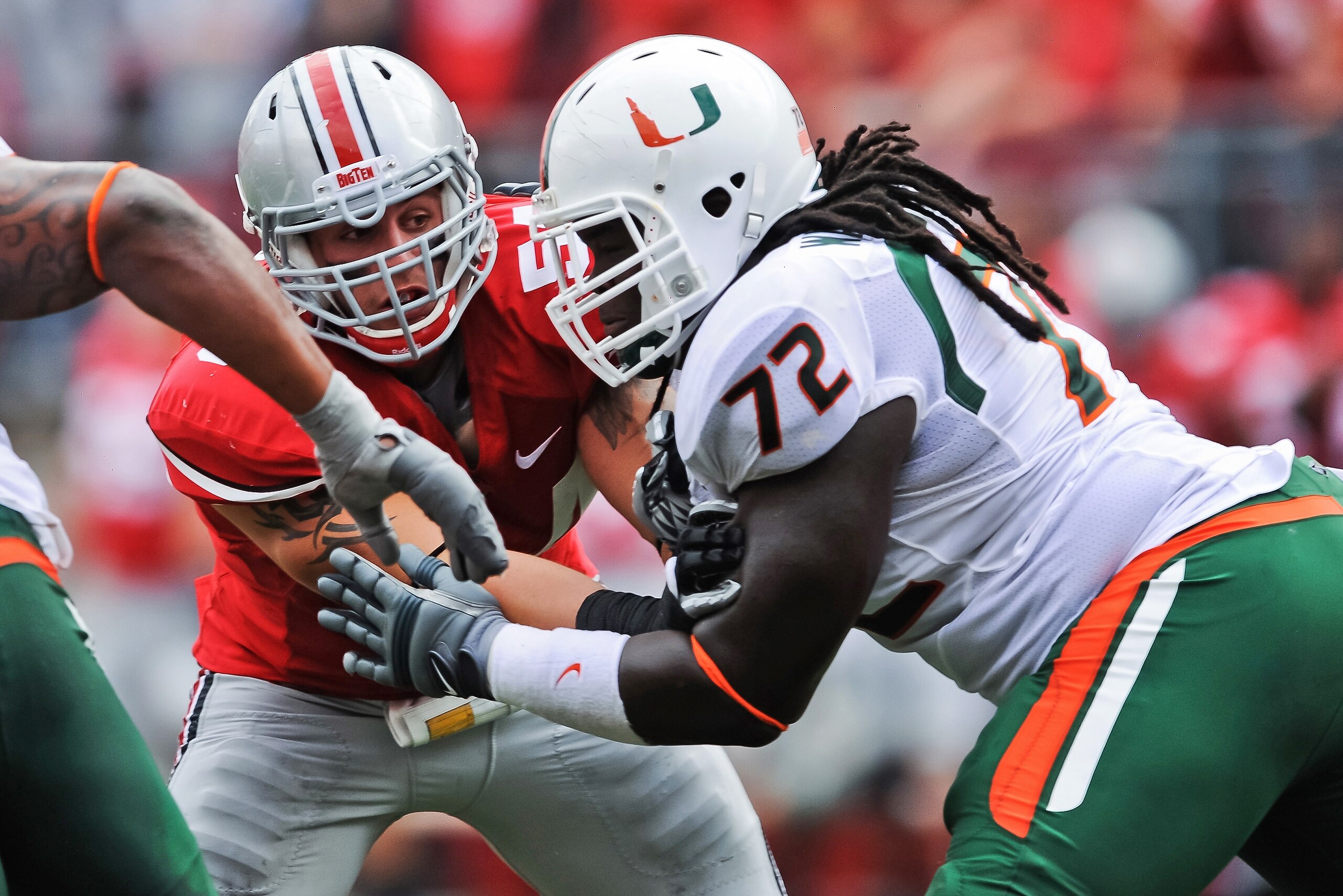 COLUMBUS, OH - SEPTEMBER 11: John Simon #54 of the Ohio State Buckeyes is blocked by Brandon Washington #72 of the Miami Hurricanes at Ohio Stadium on September 11, 2010 in Columbus, Ohio. (Photo by Jamie Sabau/Getty Images) COLUMBUS, OH - SEPTEMBER 11: John Simon #54 of the Ohio State Buckeyes is blocked by Brandon Washington #72 of the Miami Hurricanes at Ohio Stadium on September 11, 2010 in Columbus, Ohio. (Photo by Jamie Sabau/Getty Images)