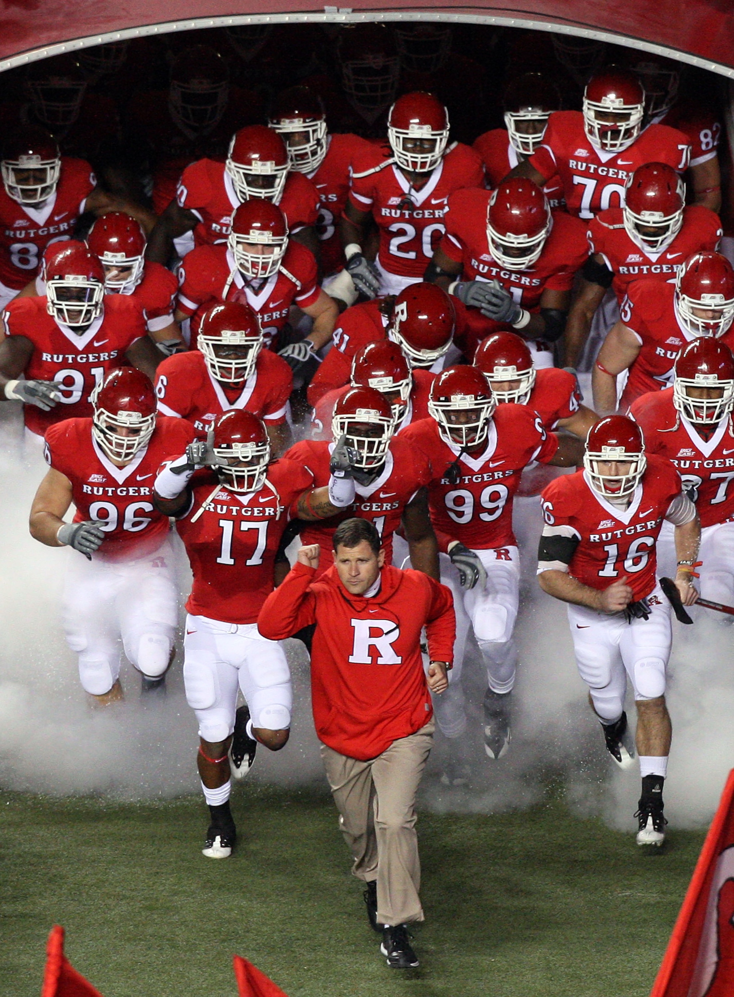 PISCATAWAY, NJ - NOVEMBER 12:  Head coach Greg Schiano of the Rutgers Scarlet Knights leads his team on the field to play against the South Florida Bulls at Rutgers Stadium on November 12, 2009 in Piscataway, New Jersey.  (Photo by Jim McIsaac/Getty Image
