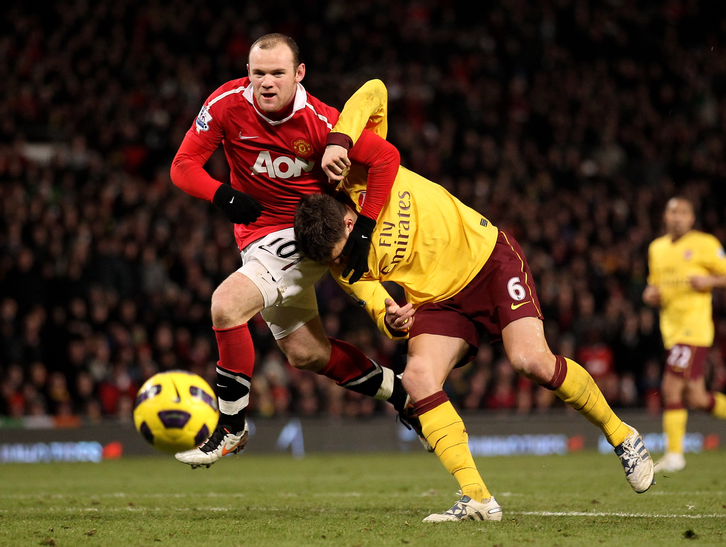 MANCHESTER, ENGLAND - DECEMBER 13:  Wayne Rooney of Manchester United tangles with Laurent Koscielny of Arsenal during the Barclays Premier League match between Manchester United and Arsenal at Old Trafford on December 13, 2010 in Manchester, England.  (P