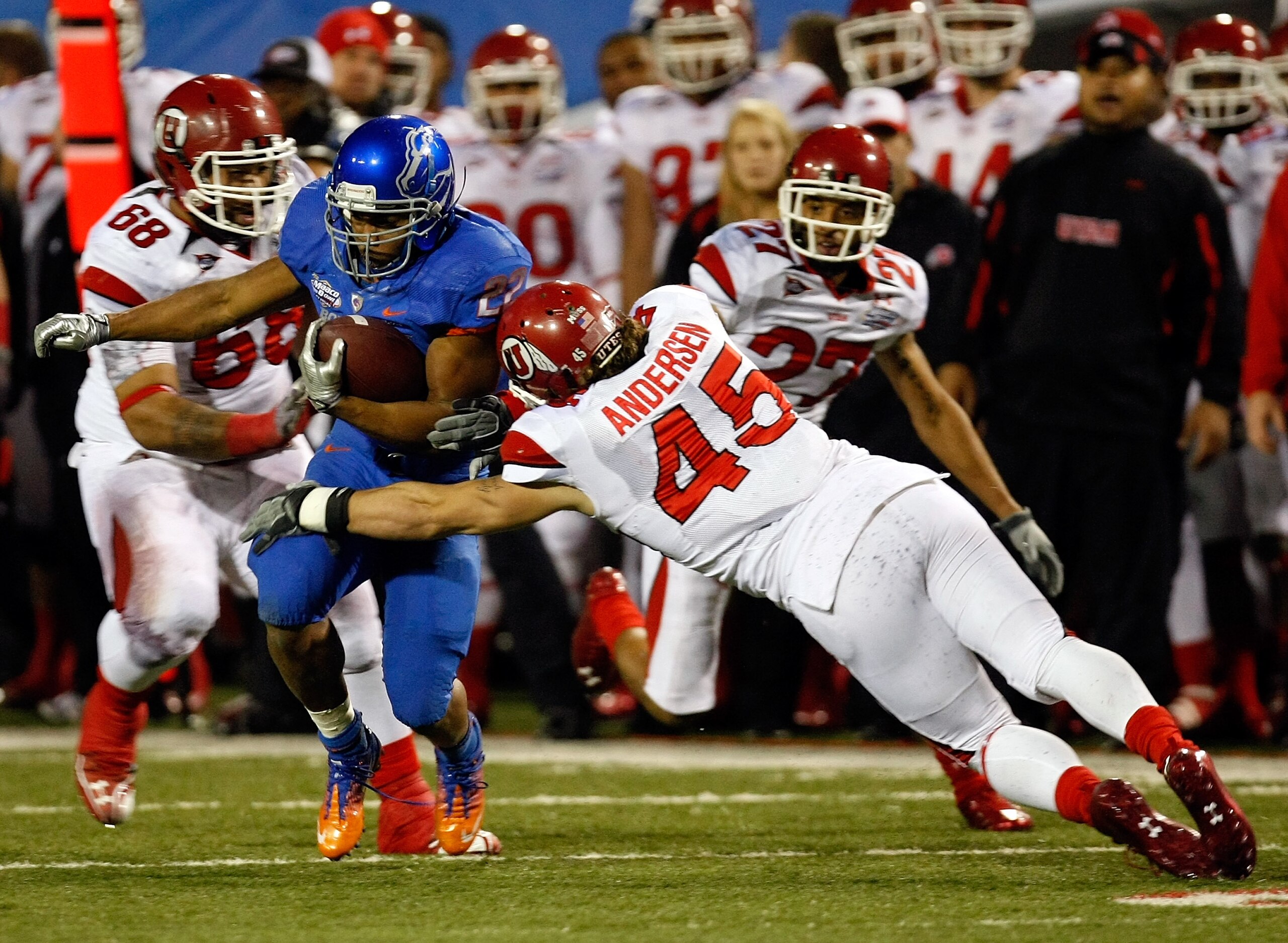 LAS VEGAS, NV - DECEMBER 22: Doug Martin #22 of the Boise State Broncos is tackled by Boo Andersen #45 of the Utah Utes during the MAACO Bowl Las Vegas at Sam Boyd Stadium December 22, 2010 in Las Vegas, Nevada. Boise State won 26-3. (Photo by Ethan Mil LAS VEGAS, NV - DECEMBER 22: Doug Martin #22 of the Boise State Broncos is tackled by Boo Andersen #45 of the Utah Utes during the MAACO Bowl Las Vegas at Sam Boyd Stadium December 22, 2010 in Las Vegas, Nevada. Boise State won 26-3. (Photo by Ethan Mil