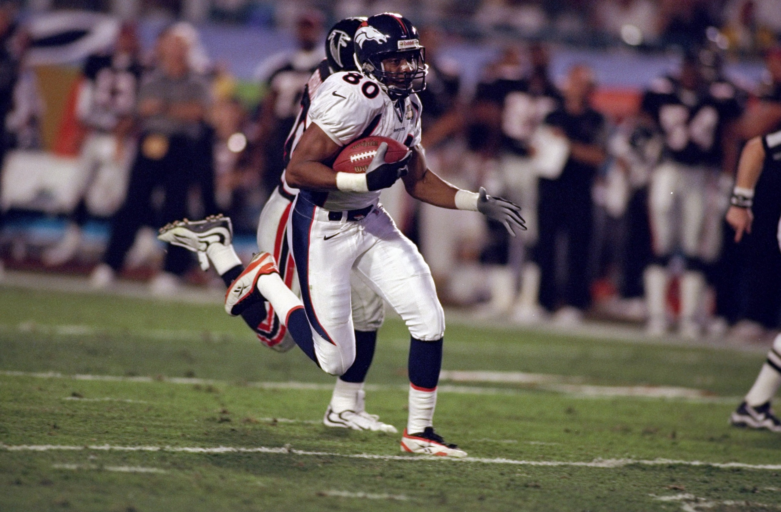 31 Jan 1999:  Rod Smith #80 of the Denver Broncos scoring a touch down with Eugene Robinson #41 chacing him during the Super Bowl XXXIII Game against the Atlanta Falcons at the Pro Player Stadium in Miami, Florida. The Broncos defeated the Falcons 34-19.