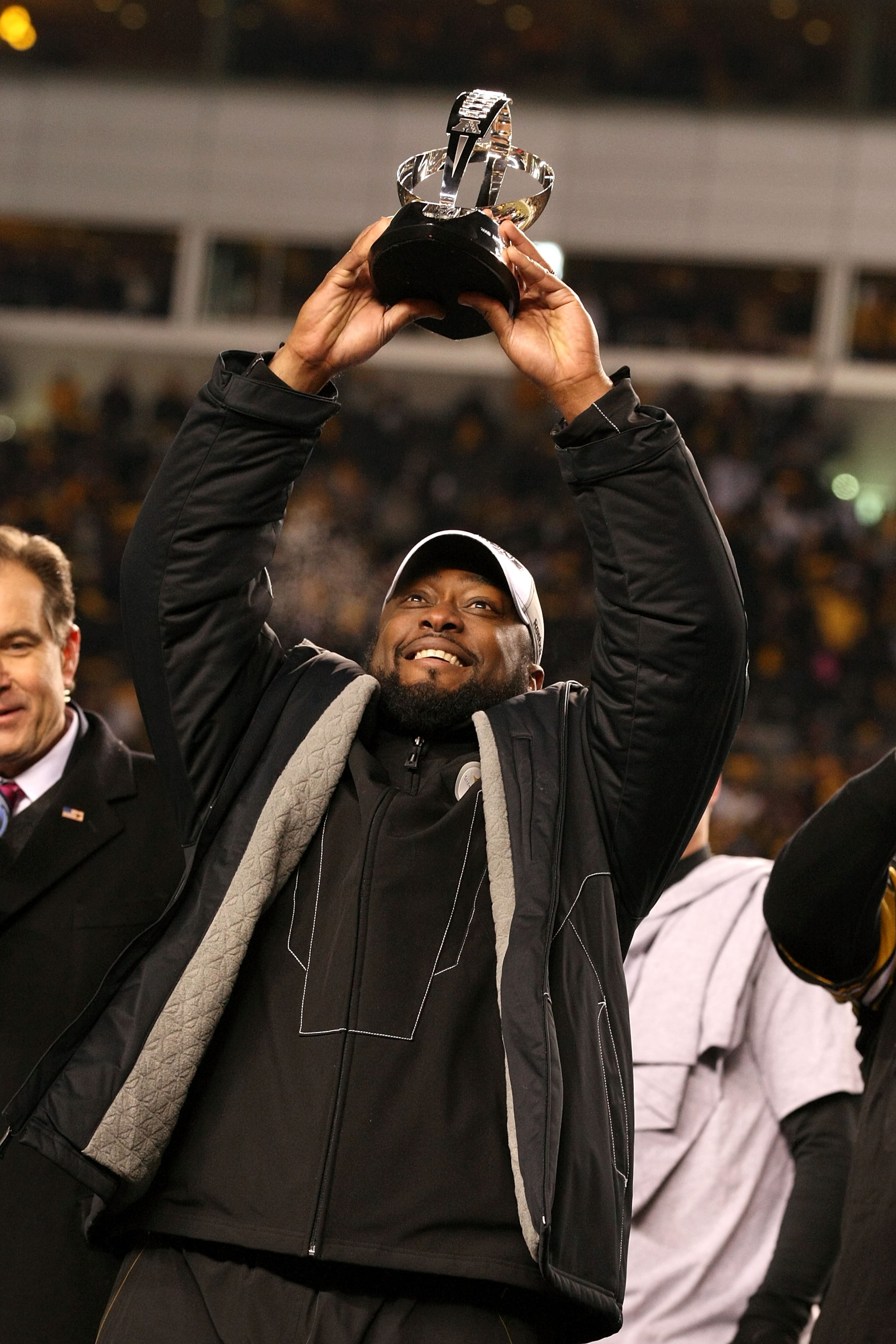 PITTSBURGH, PA - JANUARY 23:  Head coach Mike Tomlin of the Pittsburgh Steelers holds up the Lamar Hunt trophy after the Steelers defeated the New York Jets 24 to 19 in the 2011 AFC Championship game at Heinz Field on January 23, 2011 in Pittsburgh, Penns