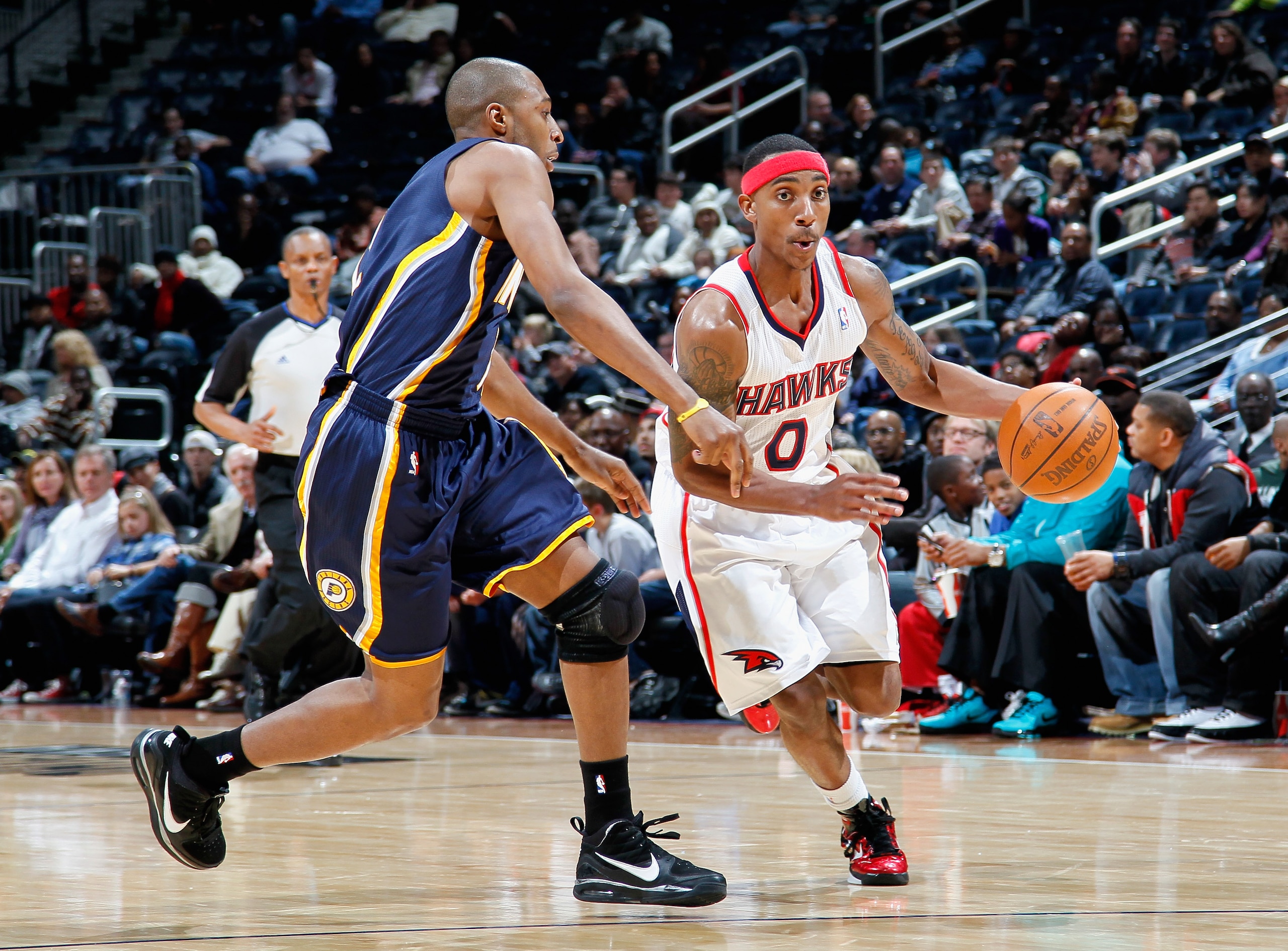 ATLANTA, GA - DECEMBER 11:  Jeff Teague #0 of the Atlanta Hawks against A.J. Price #12 of the Indiana Pacers at Philips Arena on December 11, 2010 in Atlanta, Georgia.  NOTE TO USER: User expressly acknowledges and agrees that, by downloading and/or using