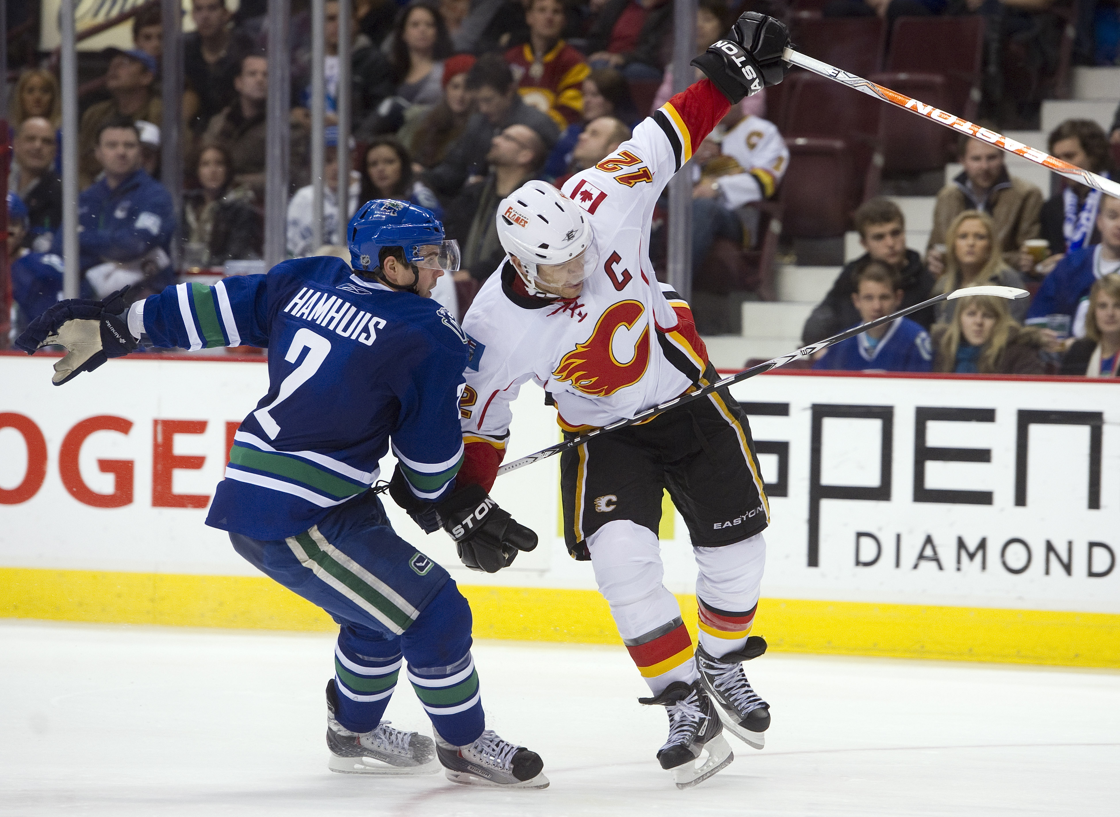 VANCOUVER, CANADA - JANUARY 22: Dan Hamhuis #2 of the Vancouver Canucks knocks Jarome Iginla #12 of the Calgary Flames off balance during the third period in NHL action on January 22, 2011 at Rogers Arena in Vancouver, British Columbia, Canada.  (Photo by