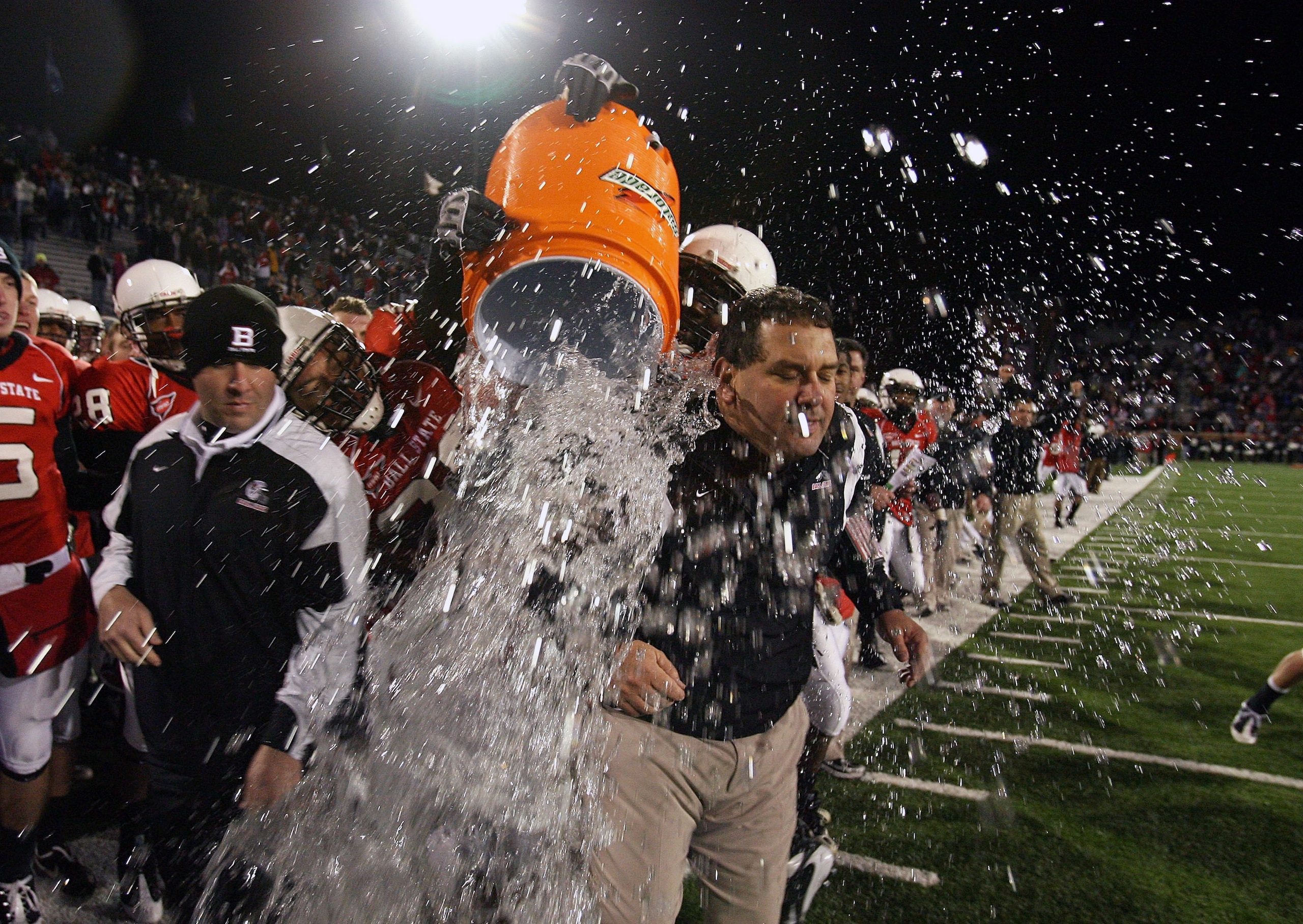 MUNCIE, IN - NOVEMBER 25:  Head coach Brady Hoke of the Ball State Cardinals is splashed with water in the final seconds of the Mid-American Conference (MAC) game against the Western Michigan Broncos at Scheumann Stadium November 25, 2008 in Muncie, India