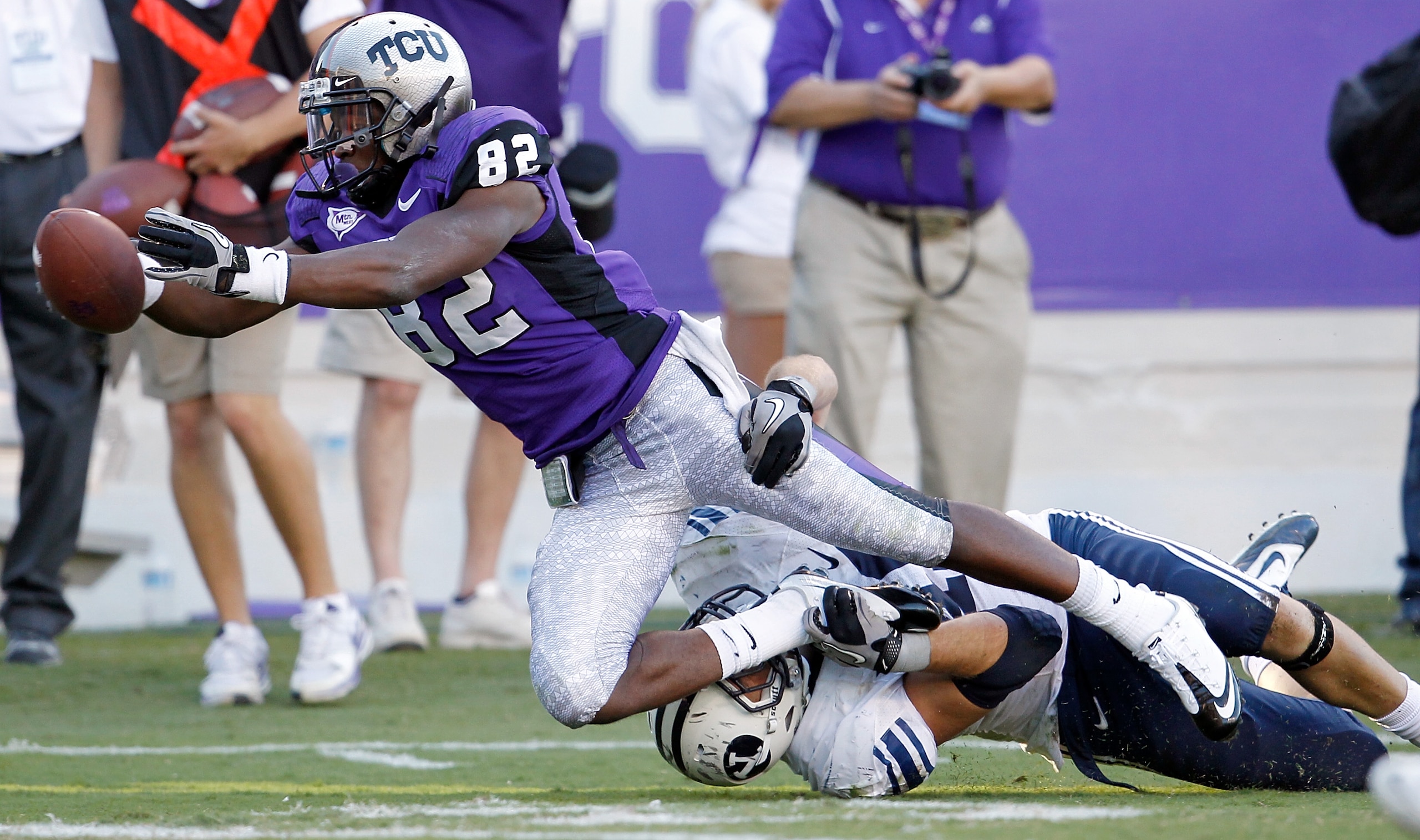 FORT WORTH, TX - OCTOBER 16:  Wide receiver Josh Boyce #82 of the TCU Horned Frogs scores a touchdown against line backer Jadon Wagner #49 the BYU Cougars at Amon G. Carter Stadium on October 16, 2010 in Fort Worth, Texas.  TCU beat BYU 31-3.  (Photo by T