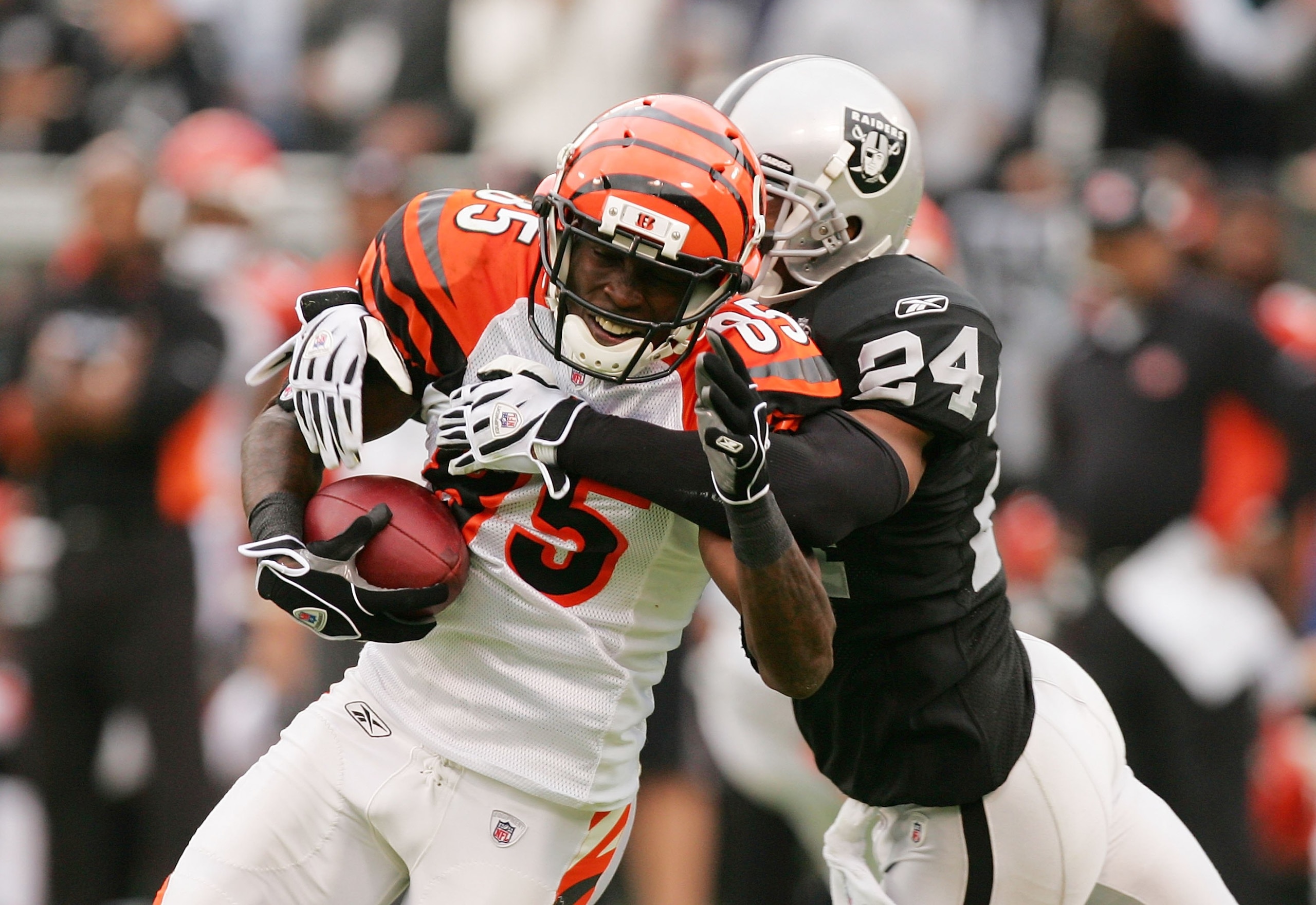 OAKLAND, CA - NOVEMBER 22: Chad Ochocinco #85 of the Cincinnati Bengals is tackled by Michael Huff #24 of the Oakland Raiders at Oakland-Alameda County Coliseum on November 22, 2009 in Oakland, California. (Photo by Ezra Shaw/Getty Images) OAKLAND, CA - NOVEMBER 22: Chad Ochocinco #85 of the Cincinnati Bengals is tackled by Michael Huff #24 of the Oakland Raiders at Oakland-Alameda County Coliseum on November 22, 2009 in Oakland, California. (Photo by Ezra Shaw/Getty Images)