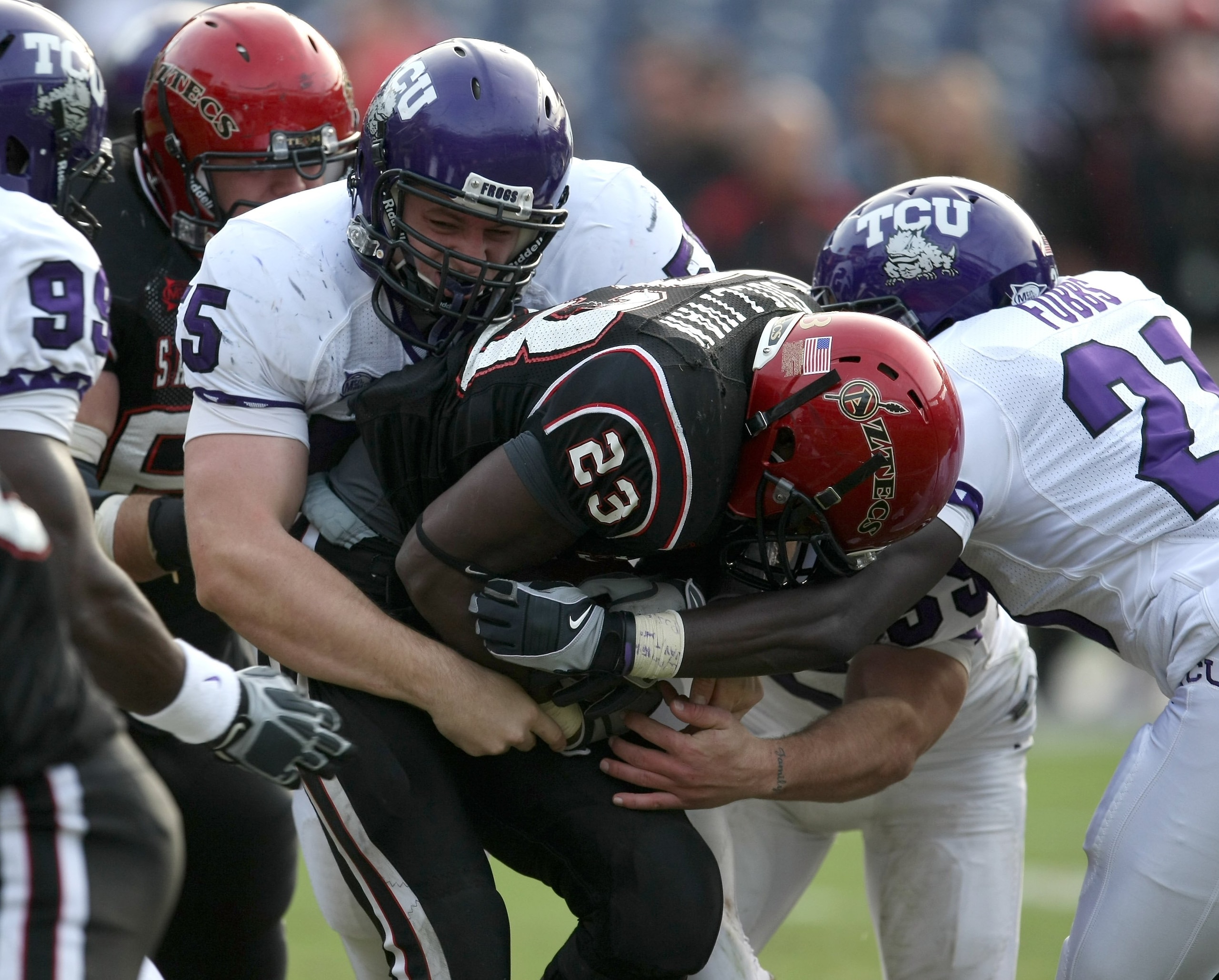 SAN DIEGO - NOVEMBER 7:  Defensive lineman D.J. Yendrey #55 of  the Texas Christian University Horned Frogs tackles runing back Brandon Sullivan #23 of the San Diego State Aztecs on November 7, 2009 at Qualcomm Stadium in San Diego, California.   TCU won
