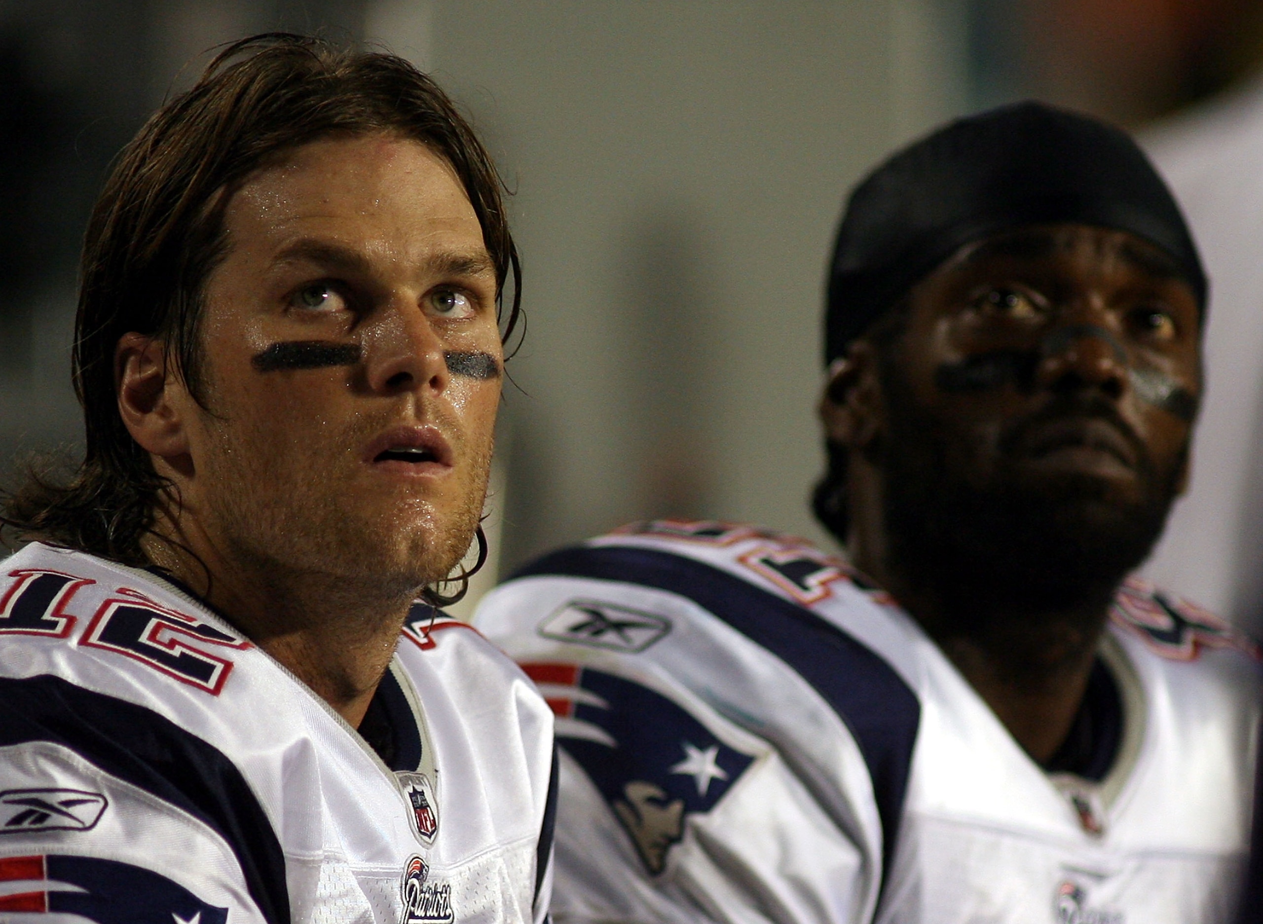 MIAMI - OCTOBER 04: Quarterback Tom Brady #12 and Randy Moss of the New England Patriots sit on the sidelines against the Miami Dolphins at Sun Life Stadium on October 4, 2010 in Miami, Florida. (Photo by Marc Serota/Getty Images) MIAMI - OCTOBER 04: Quarterback Tom Brady #12 and Randy Moss of the New England Patriots sit on the sidelines against the Miami Dolphins at Sun Life Stadium on October 4, 2010 in Miami, Florida. (Photo by Marc Serota/Getty Images)